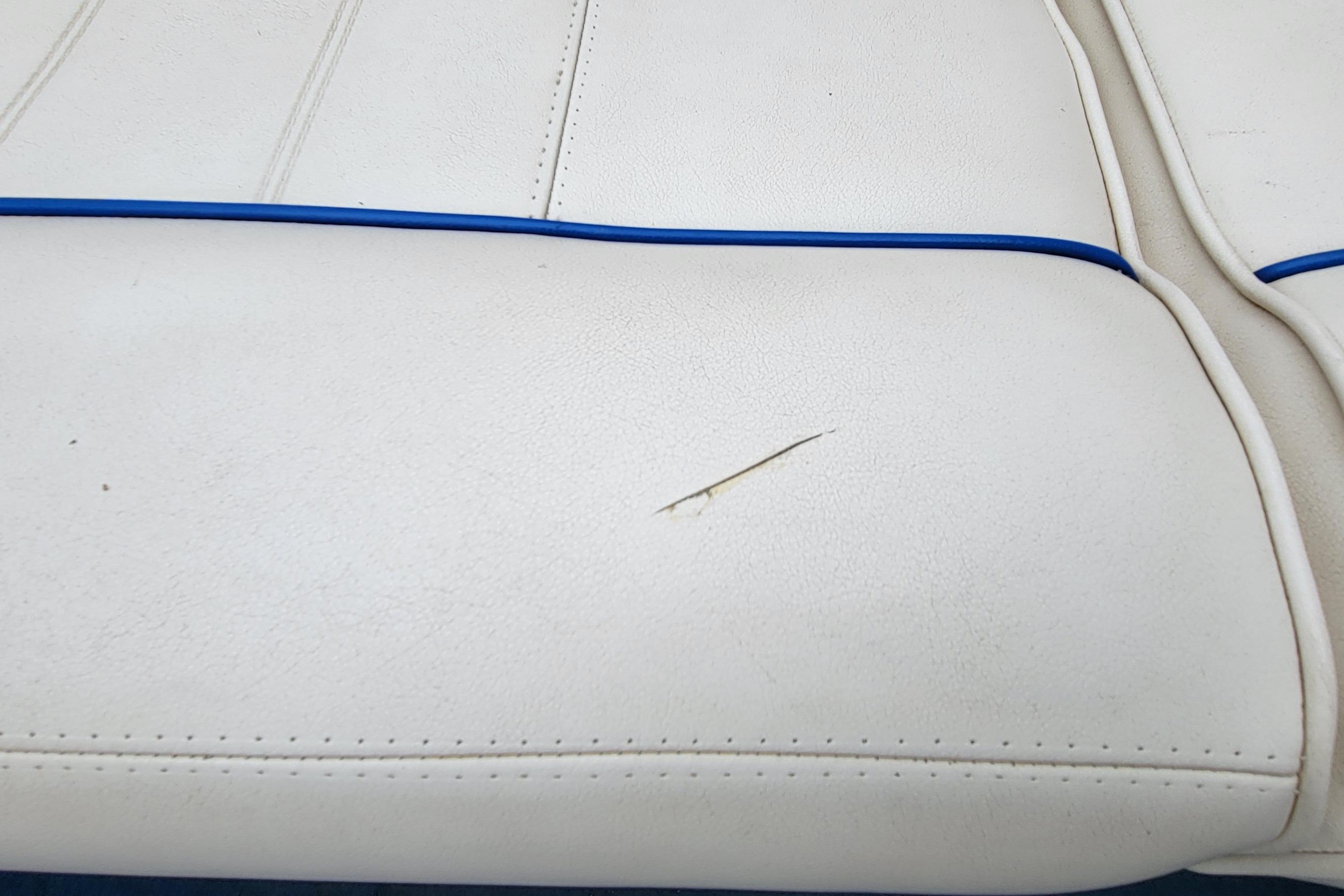 White boat seat with a tear, from a 1994 Sea Ray 180 Bow Rider.