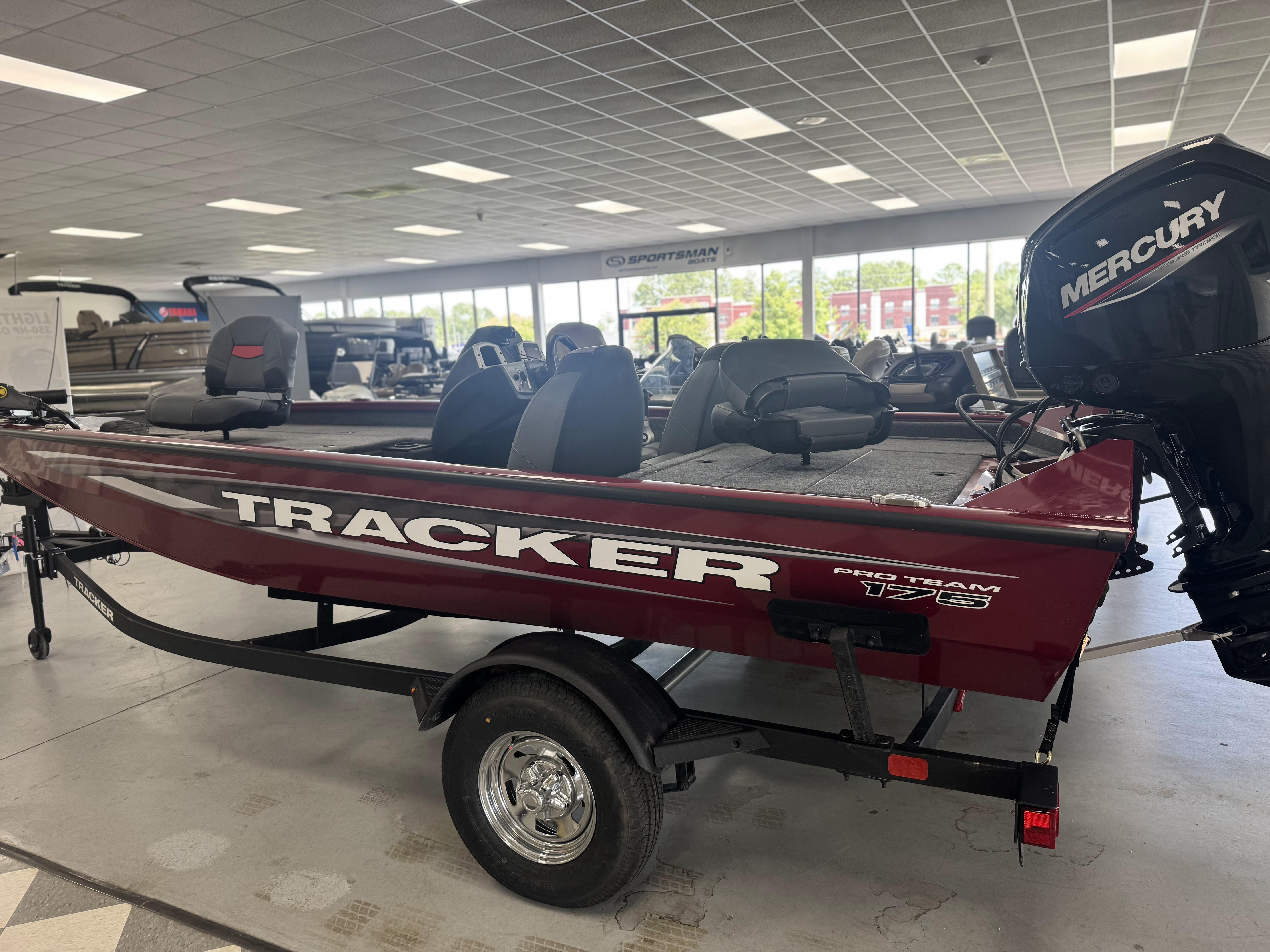 2025 Tracker Pro Team 175 boat in showroom with Mercury engine.