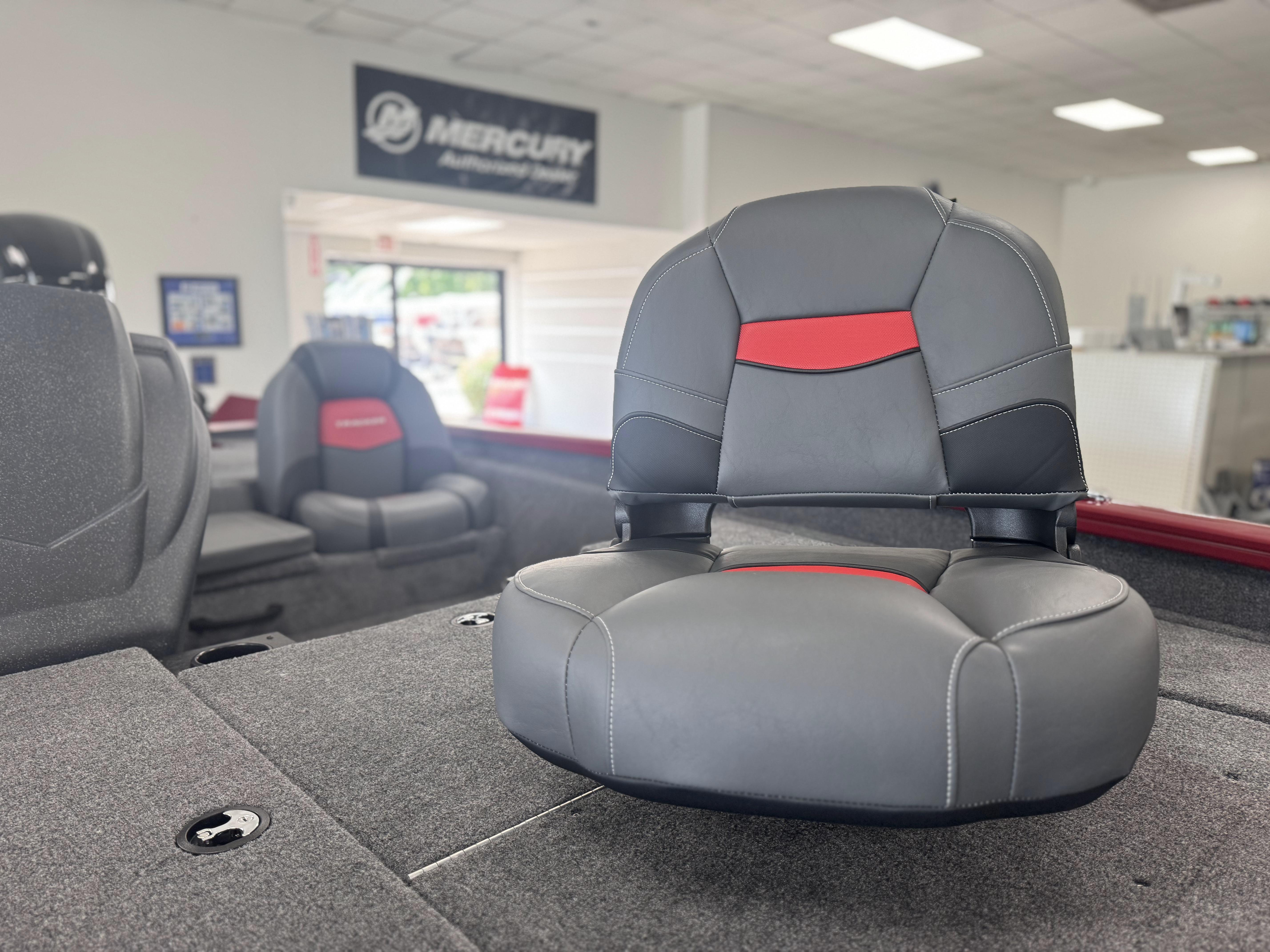 2025 Tracker Pro Team 175 boat seat in showroom, featuring gray and red upholstery.