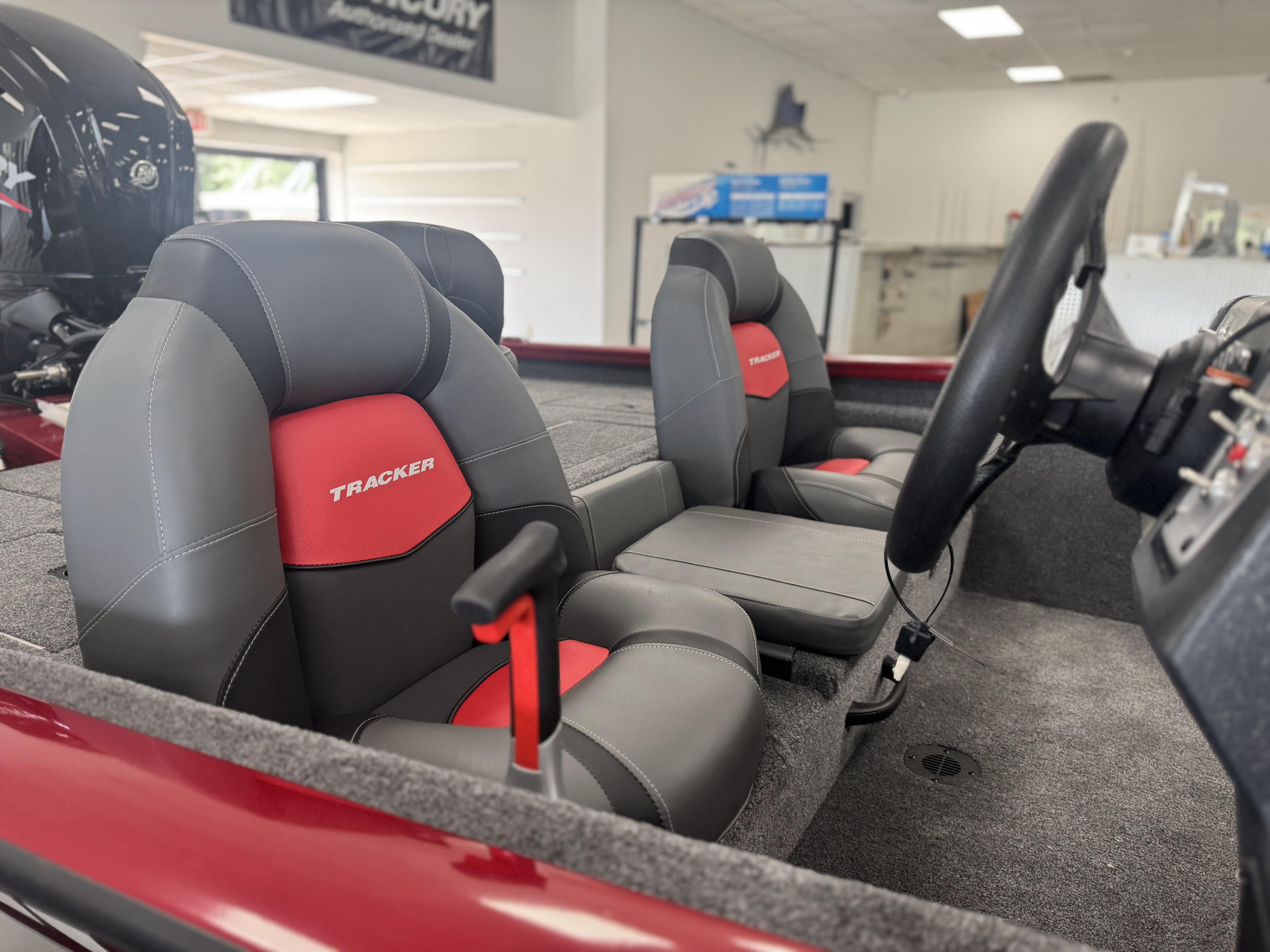 2025 Tracker Pro Team 175 boat interior with gray and red seats, steering wheel visible.