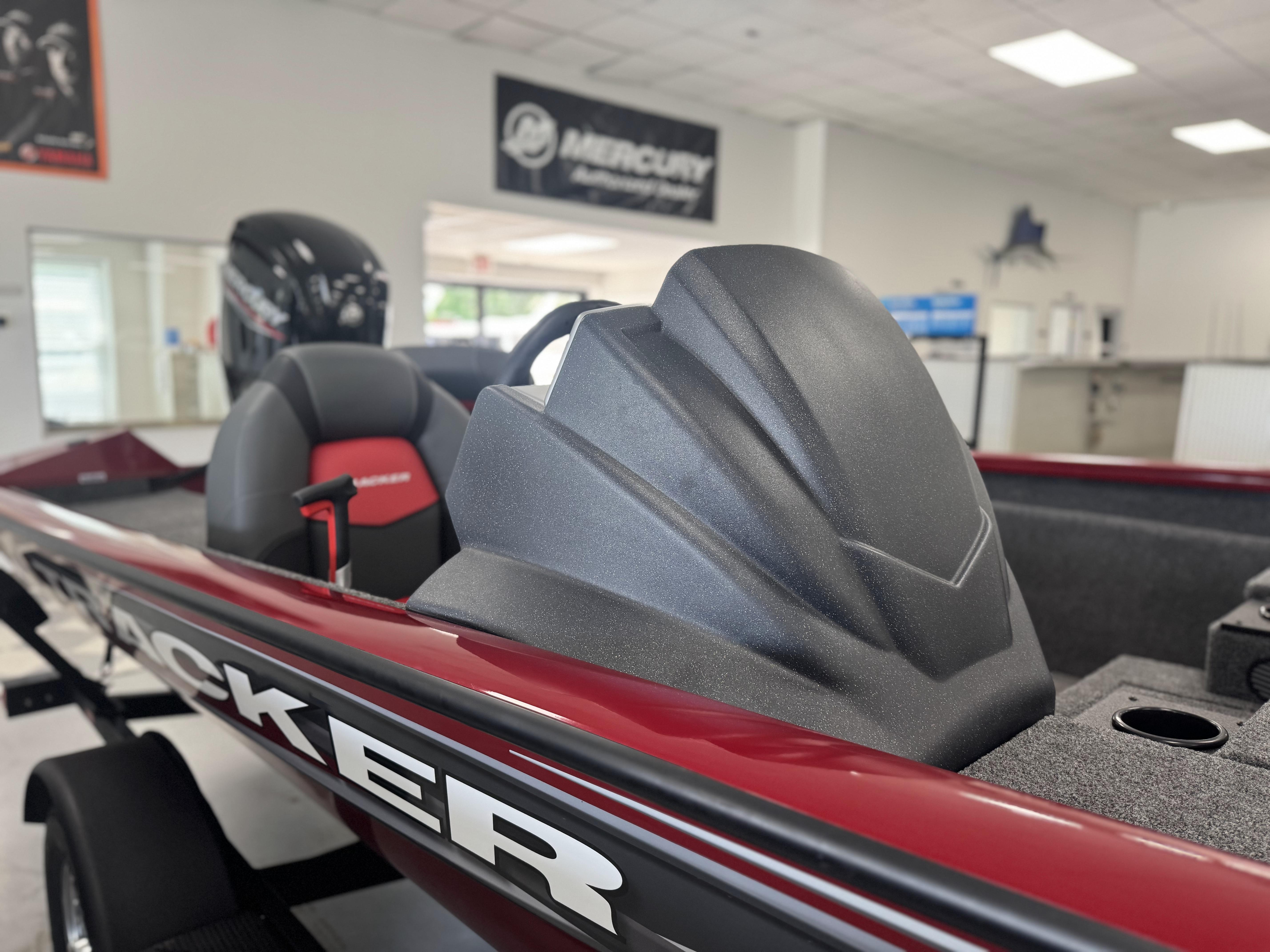 2025 Tracker Pro Team 175 boat interior with seating and motor, displayed indoors.