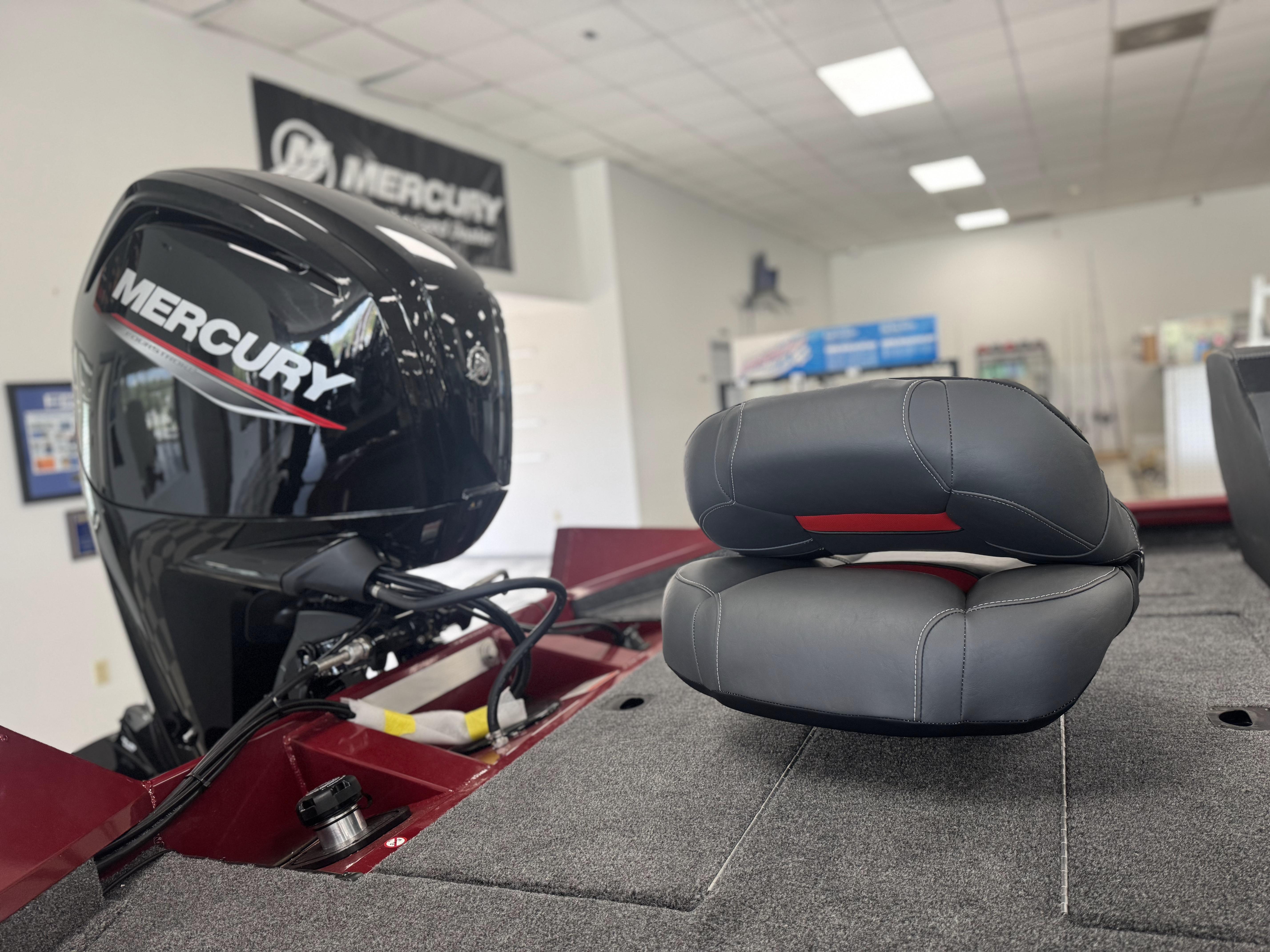 2025 Tracker Pro Team 175 boat with Mercury engine in showroom.