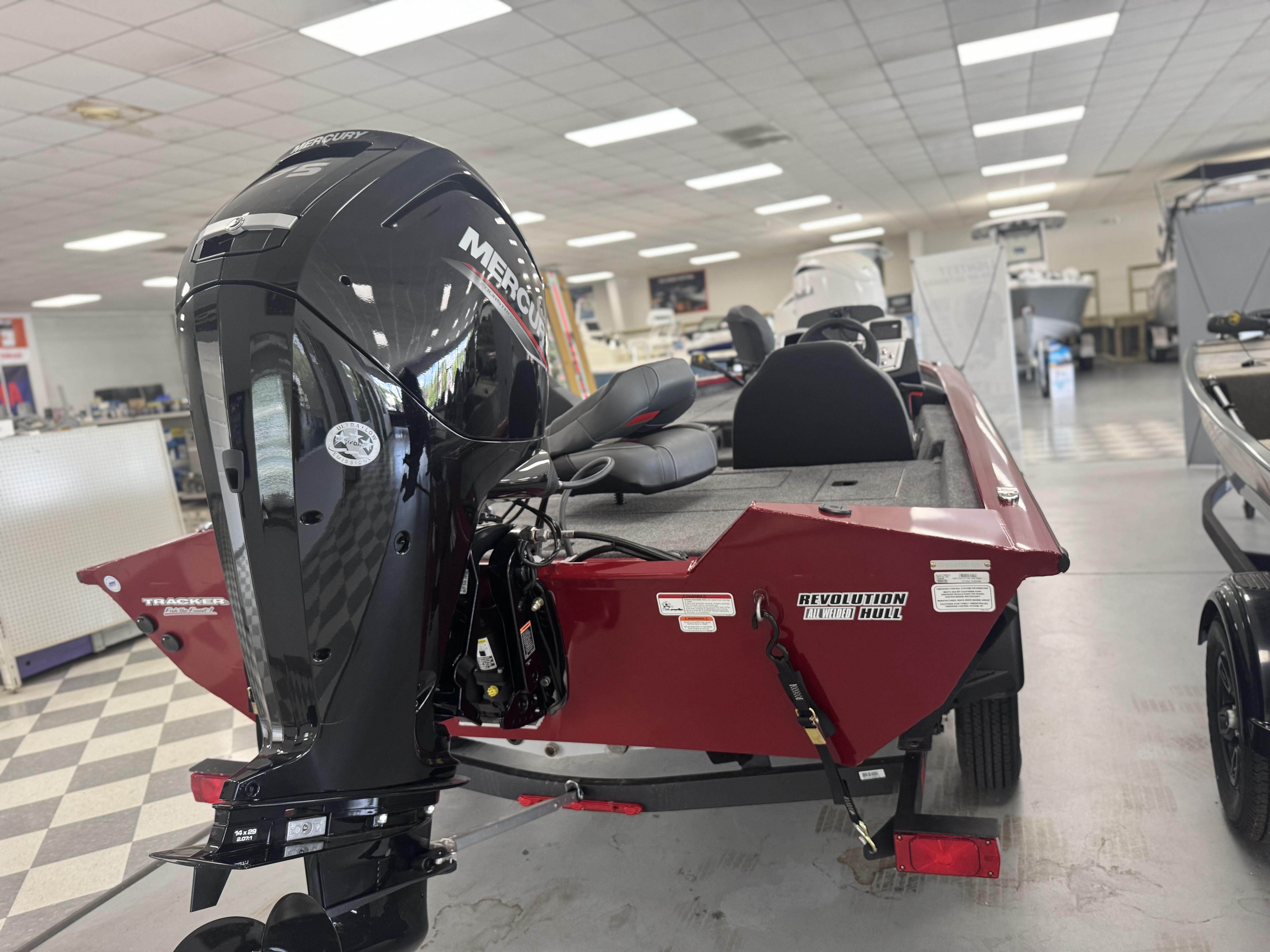 2025 Tracker Pro Team 175 boat with Mercury engine in showroom.