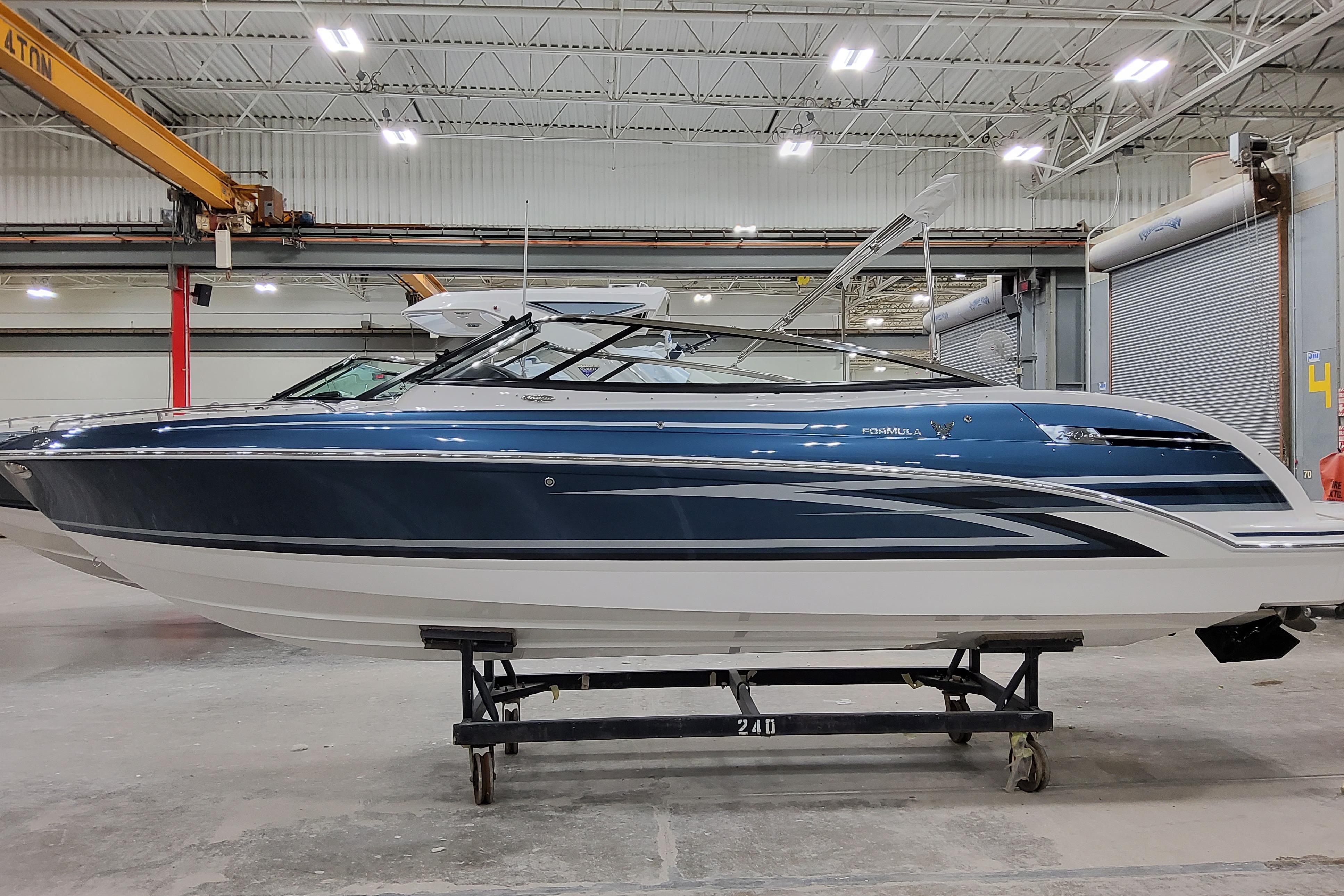 2026 Formula 240 Bowrider boat in a warehouse, side view.