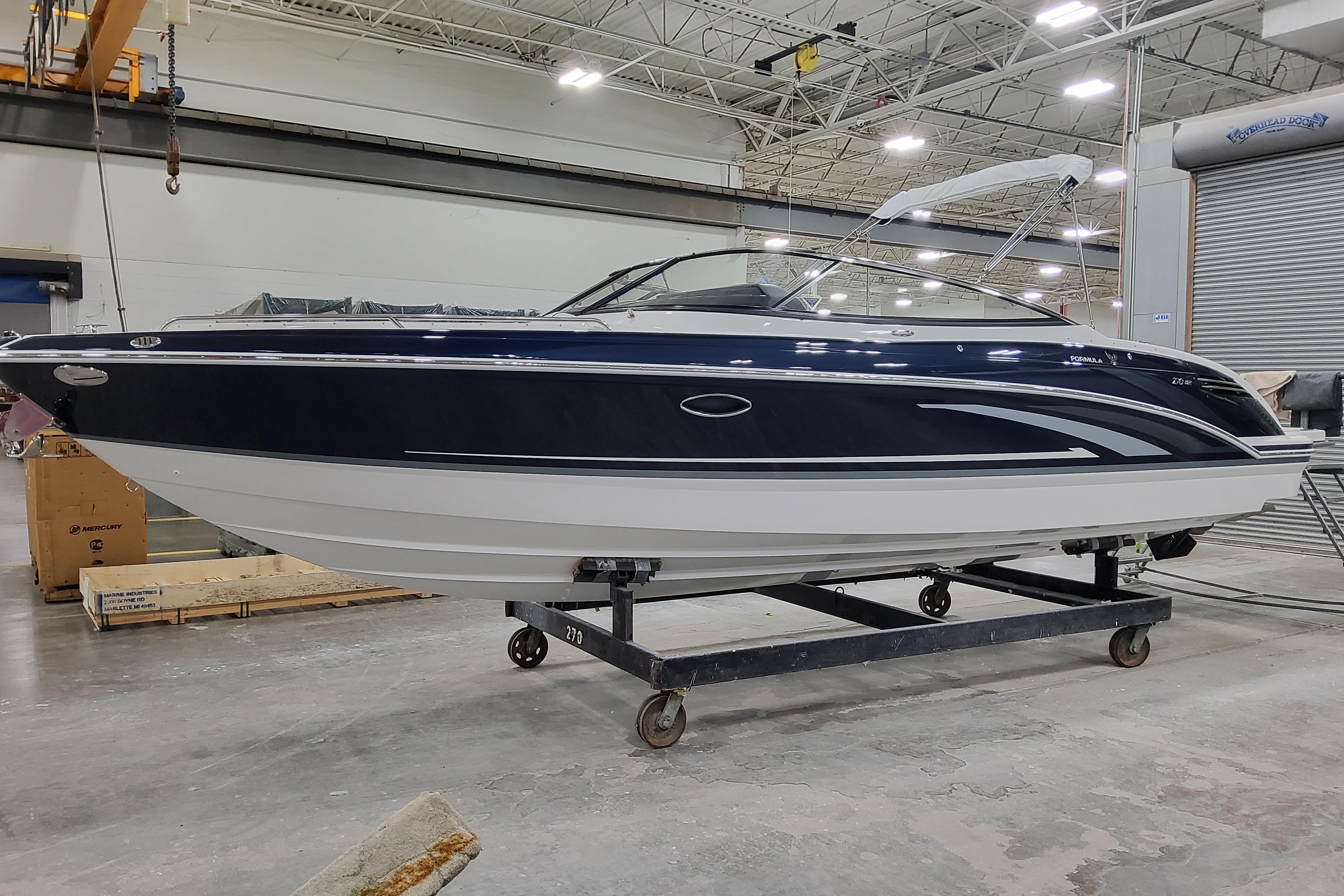 2026 Formula 270 Bowrider boat in a warehouse setting, side view.