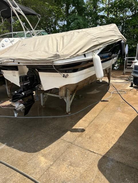 2011 Chaparral 216 SSi boat covered and docked outdoors.