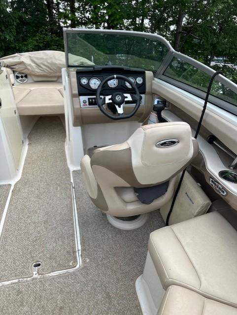 2011 Chaparral 216 SSi boat interior with beige seating and steering console.