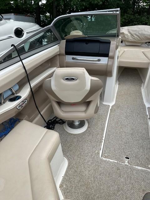 2011 Chaparral 216 SSi boat interior with beige seating and steering console.