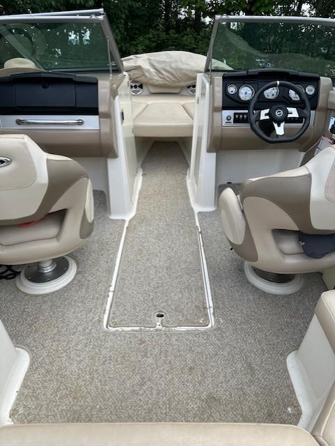 Interior of 2011 Chaparral 216 SSi boat with beige seating and dashboard.