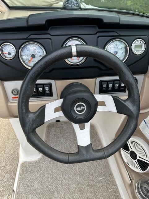 Steering wheel and dashboard of 2011 Chaparral 216 SSi boat with gauges and controls.