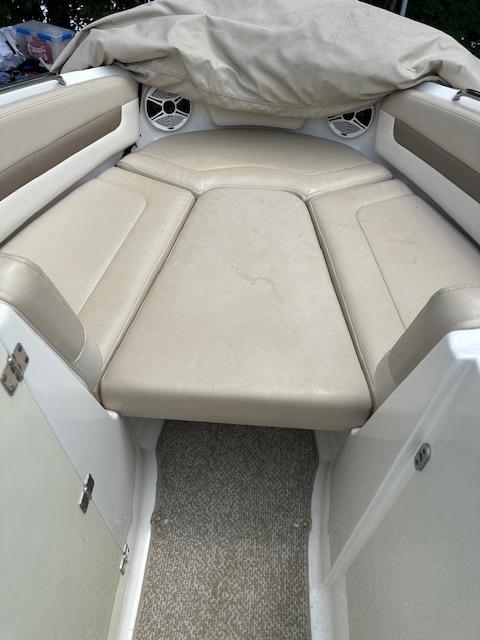 2011 Chaparral 216 SSi boat interior with beige seating and covered bow area.