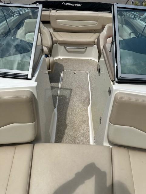 2011 Chaparral 216 SSi boat interior with beige seating and open windshield.
