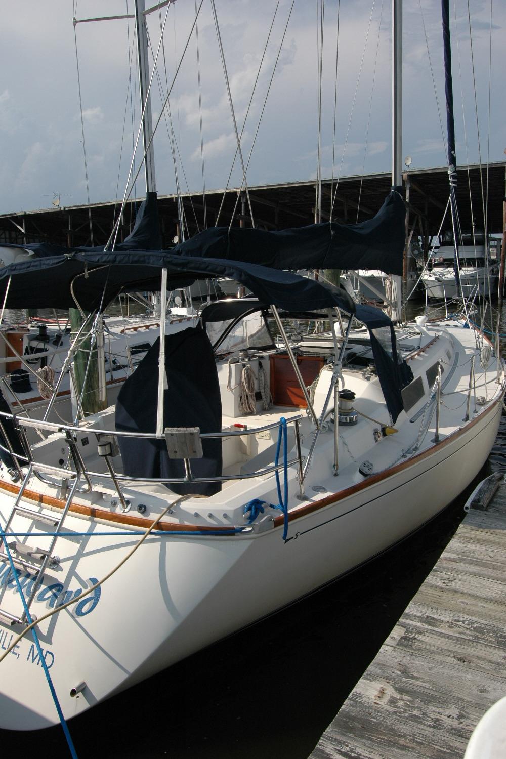 1988 Sabre 38 MkII sailboat docked at marina, featuring sleek design and covered cockpit.