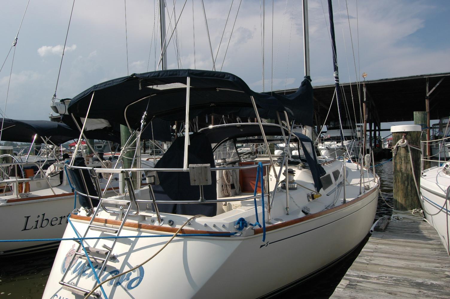 1988 Sabre 38 MkII sailboat docked at marina under clear sky.
