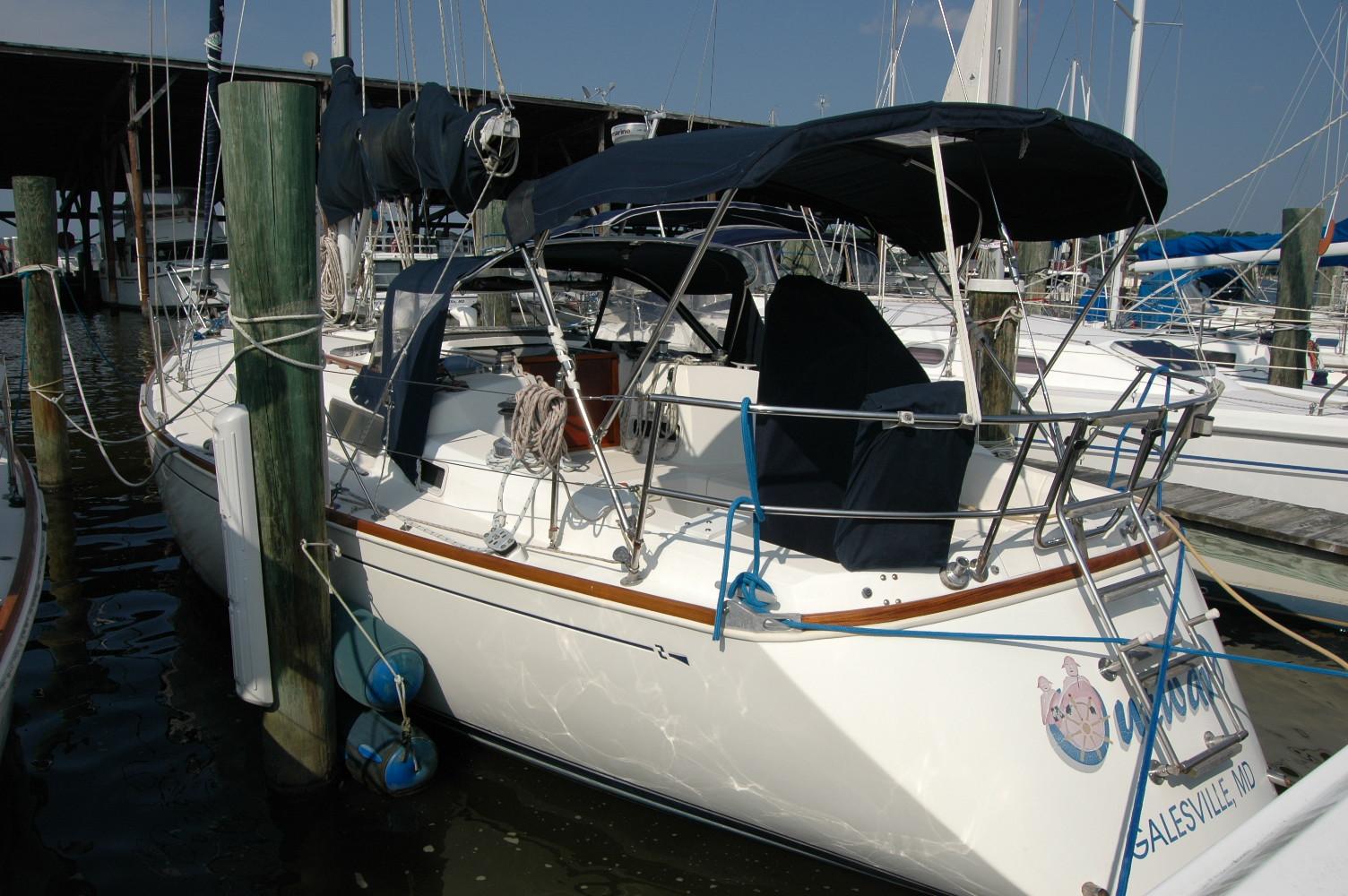 1988 Sabre 38 MkII sailboat docked at a marina, featuring a covered cockpit.