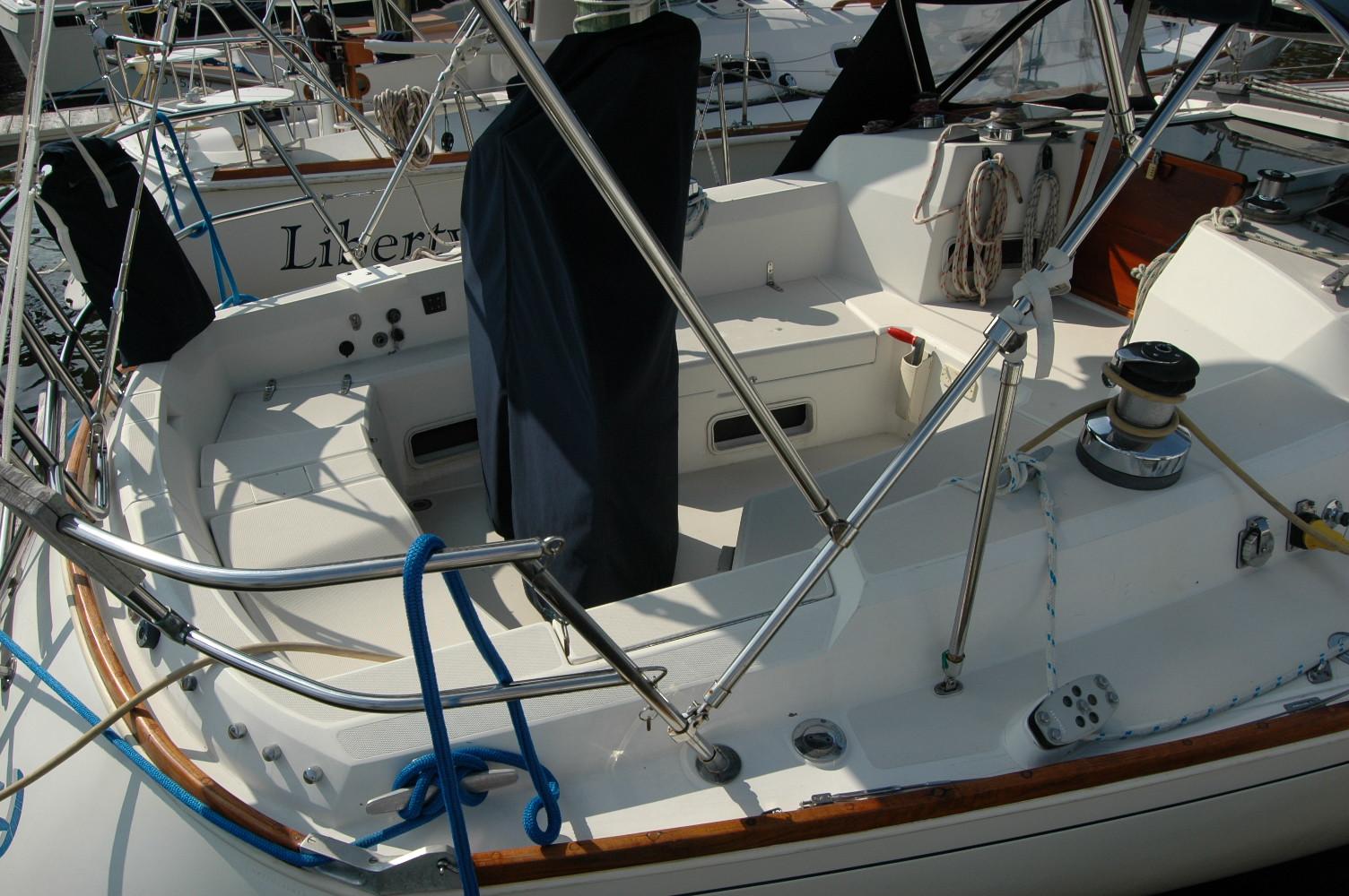 1988 Sabre 38 MkII sailboat cockpit with winches and ropes, docked in a marina.