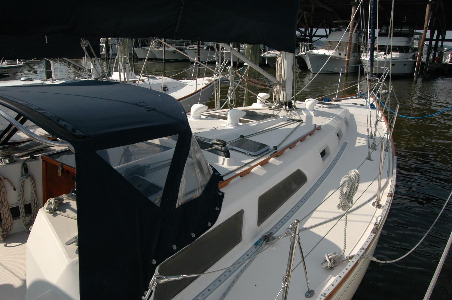 1988 Sabre 38 MkII sailboat docked, featuring a sleek design and covered cockpit.