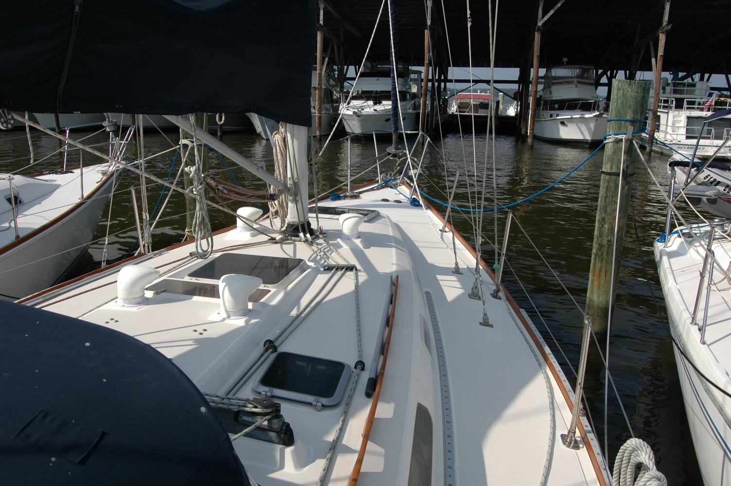 1988 Sabre 38 MkII sailboat docked in a marina, surrounded by other boats.