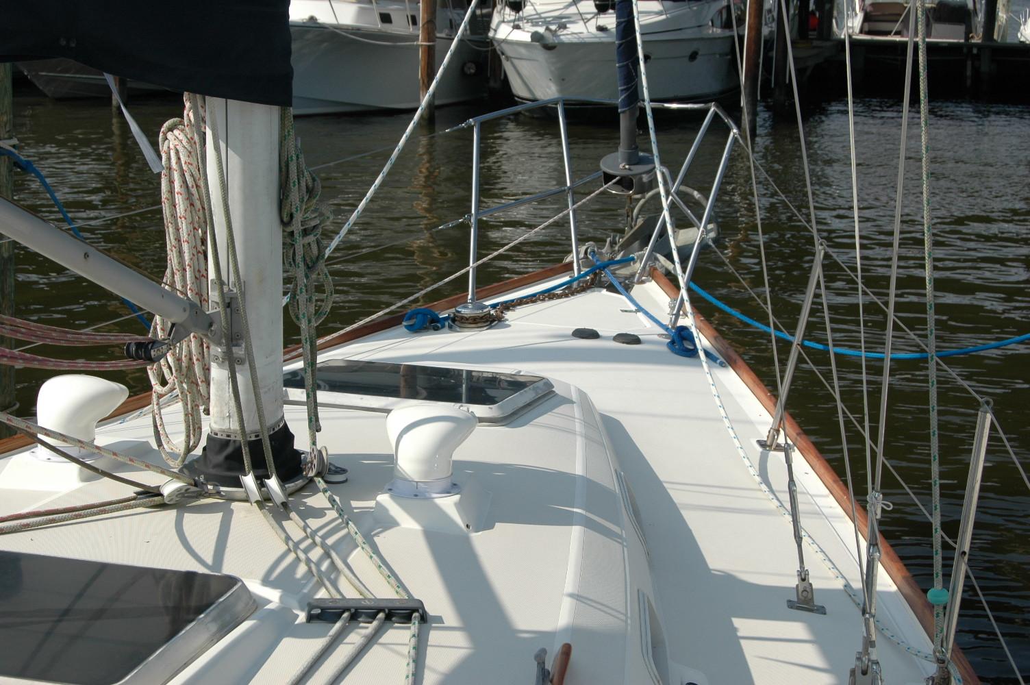 1988 Sabre 38 MkII sailboat deck with rigging and docked boats in background.