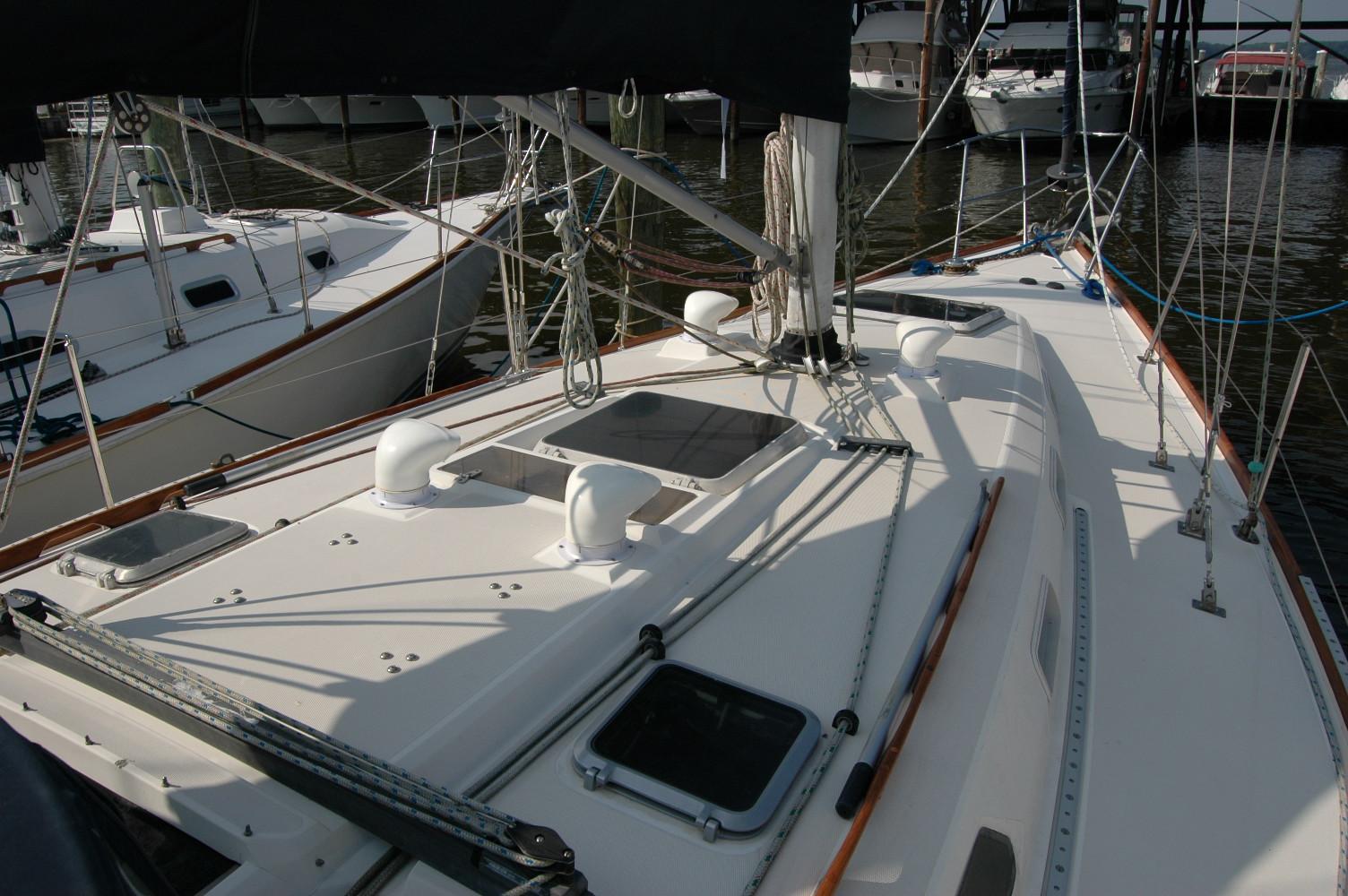 1988 Sabre 38 MkII sailboat deck with rigging and hatches in marina.