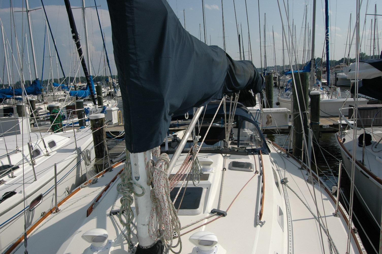 1988 Sabre 38 MkII sailboat docked in a marina, surrounded by other vessels.
