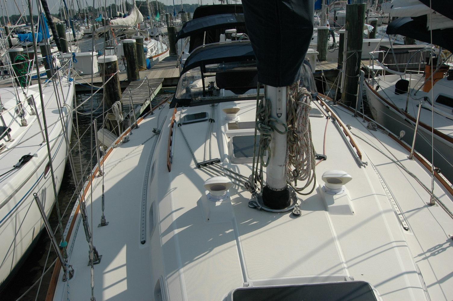 1988 Sabre 38 MkII sailboat docked at a marina, surrounded by other boats.