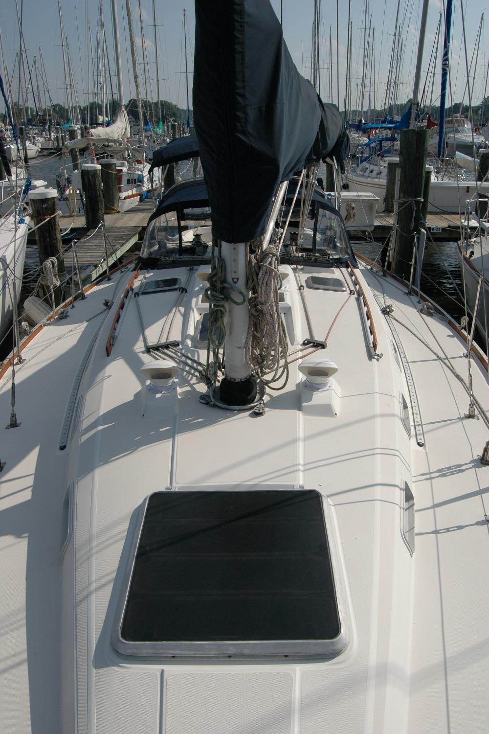 1988 Sabre 38 MkII sailboat docked at marina, view of deck and mast.