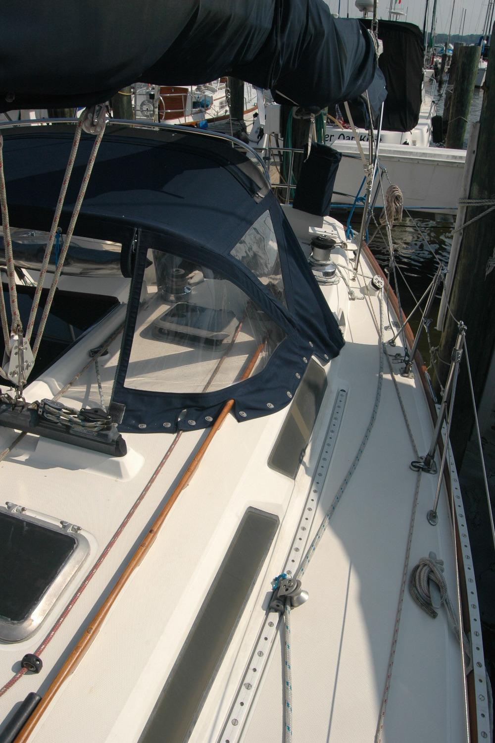1988 Sabre 38 MkII sailboat docked, featuring a sleek deck and navy blue canopy.