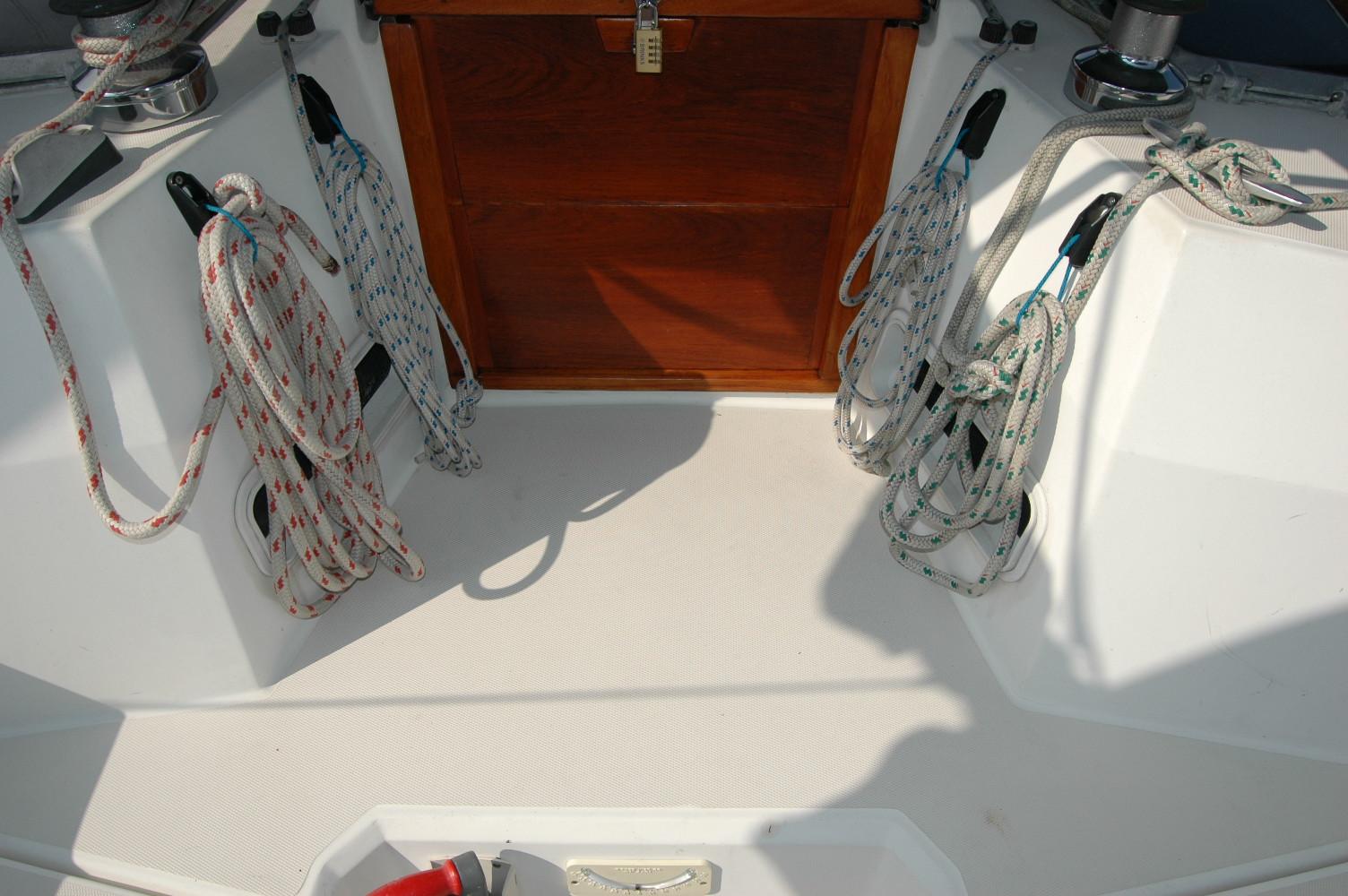 Cockpit of 1988 Sabre 38 MkII sailboat with ropes and wooden hatch.