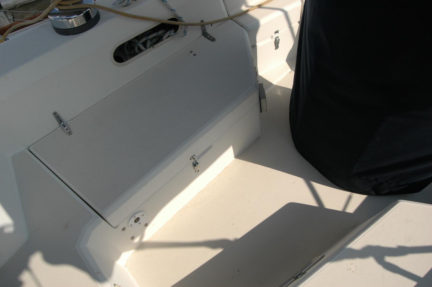 1988 Sabre 38 MkII yacht cockpit with storage compartment and covered wheel.