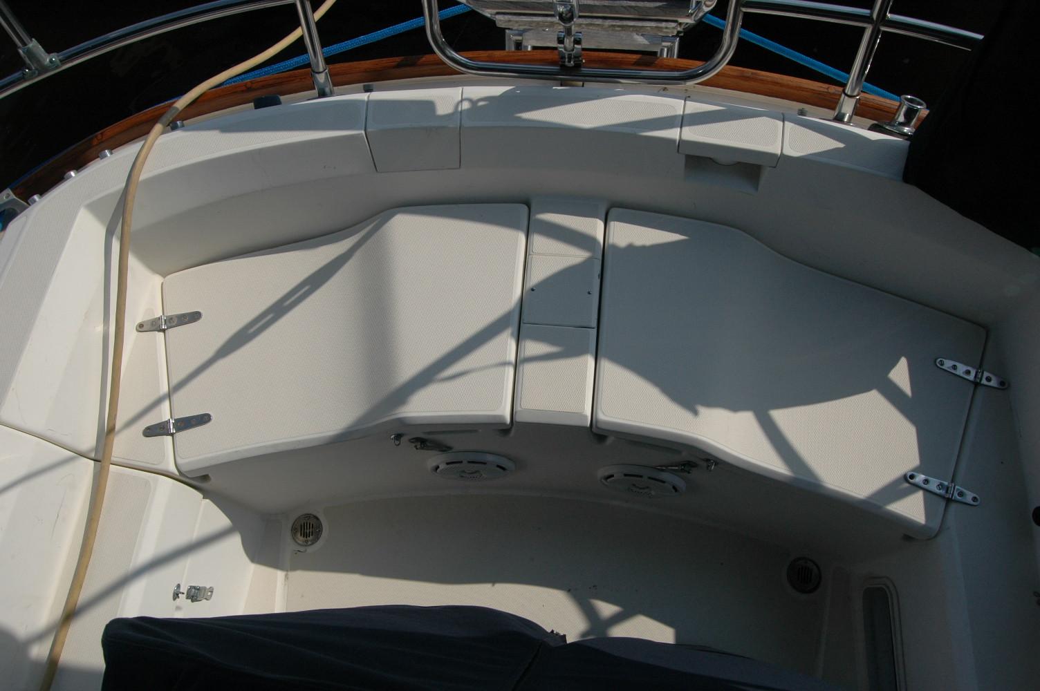 Cockpit seating area of a 1988 Sabre 38 MkII sailboat, featuring white cushioned benches.