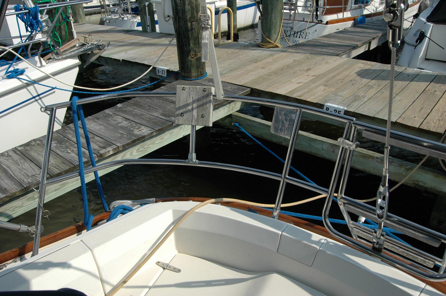1988 Sabre 38 MkII sailboat docked, featuring stainless steel railings and wooden dock.
