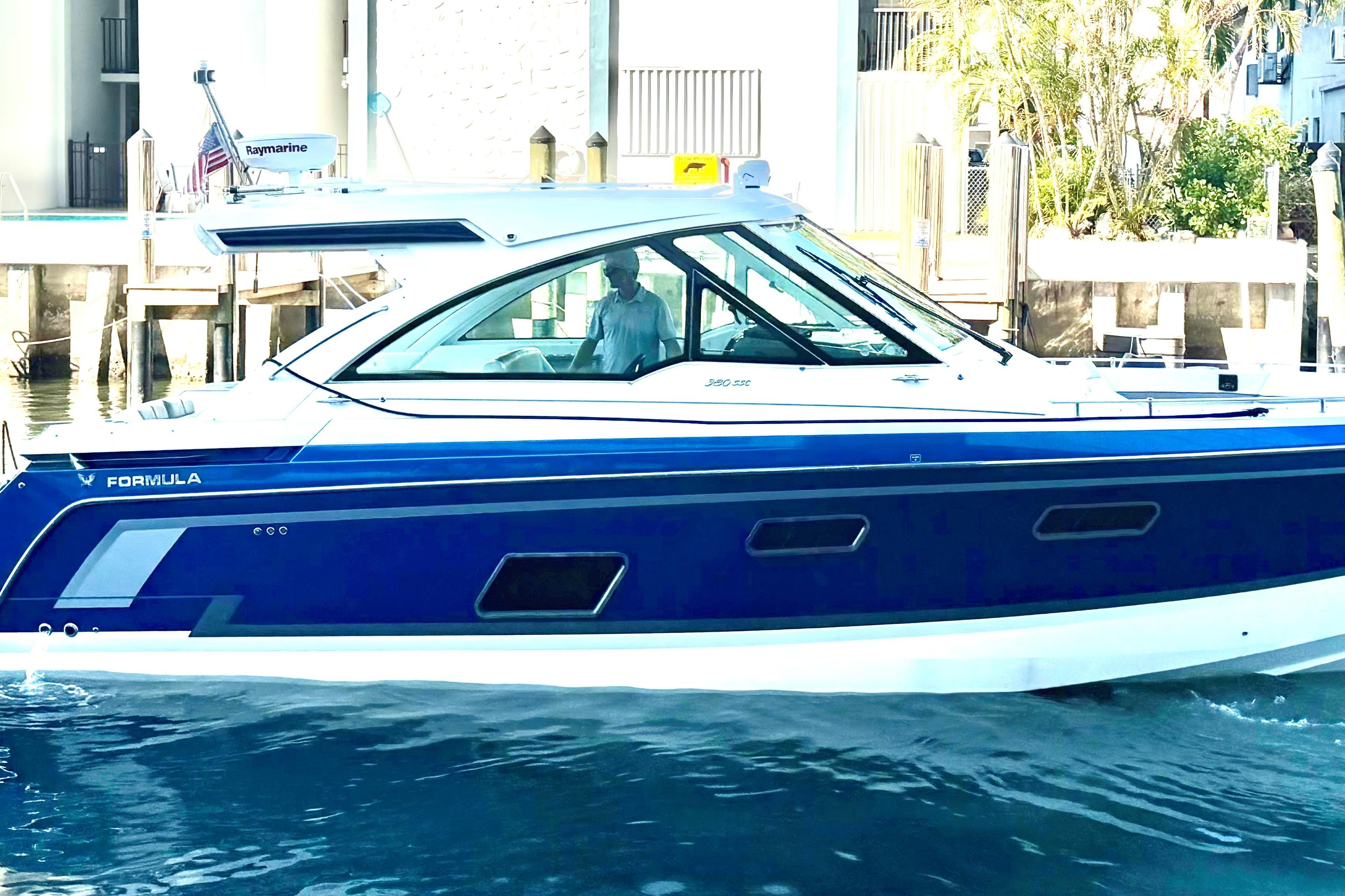 2023 Formula 380 Super Sport Crossover OB boat on water, side view.