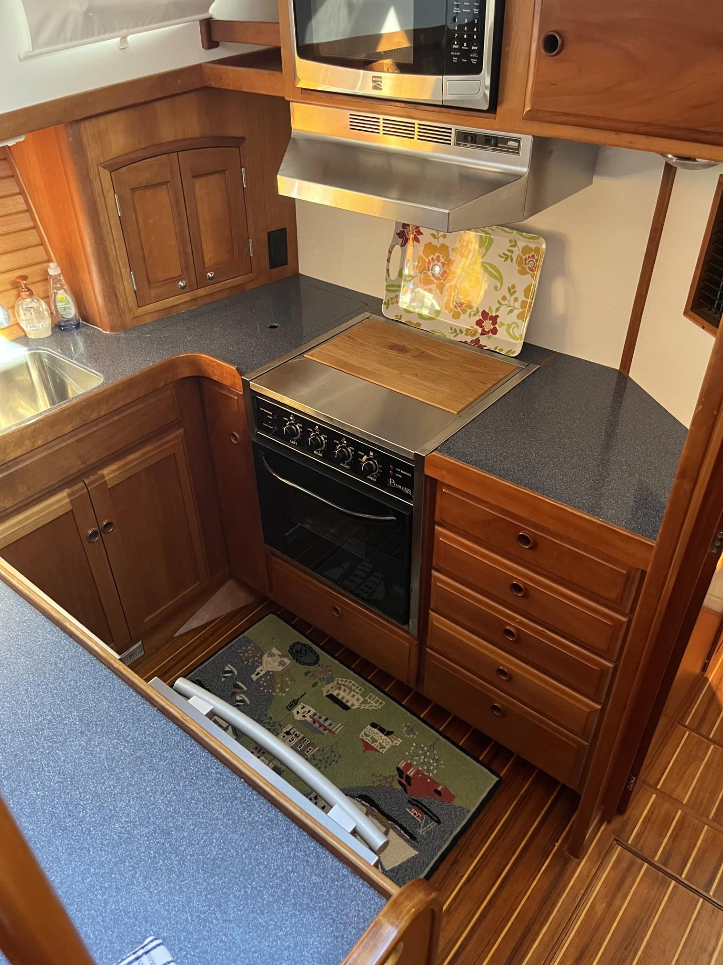 Sabre-Sabreline 47 1999-CANDY O RI-US-1999 Sabre Sabreline 47 yacht kitchen with wooden cabinetry and modern appliances.-9522318 | Thumbnail