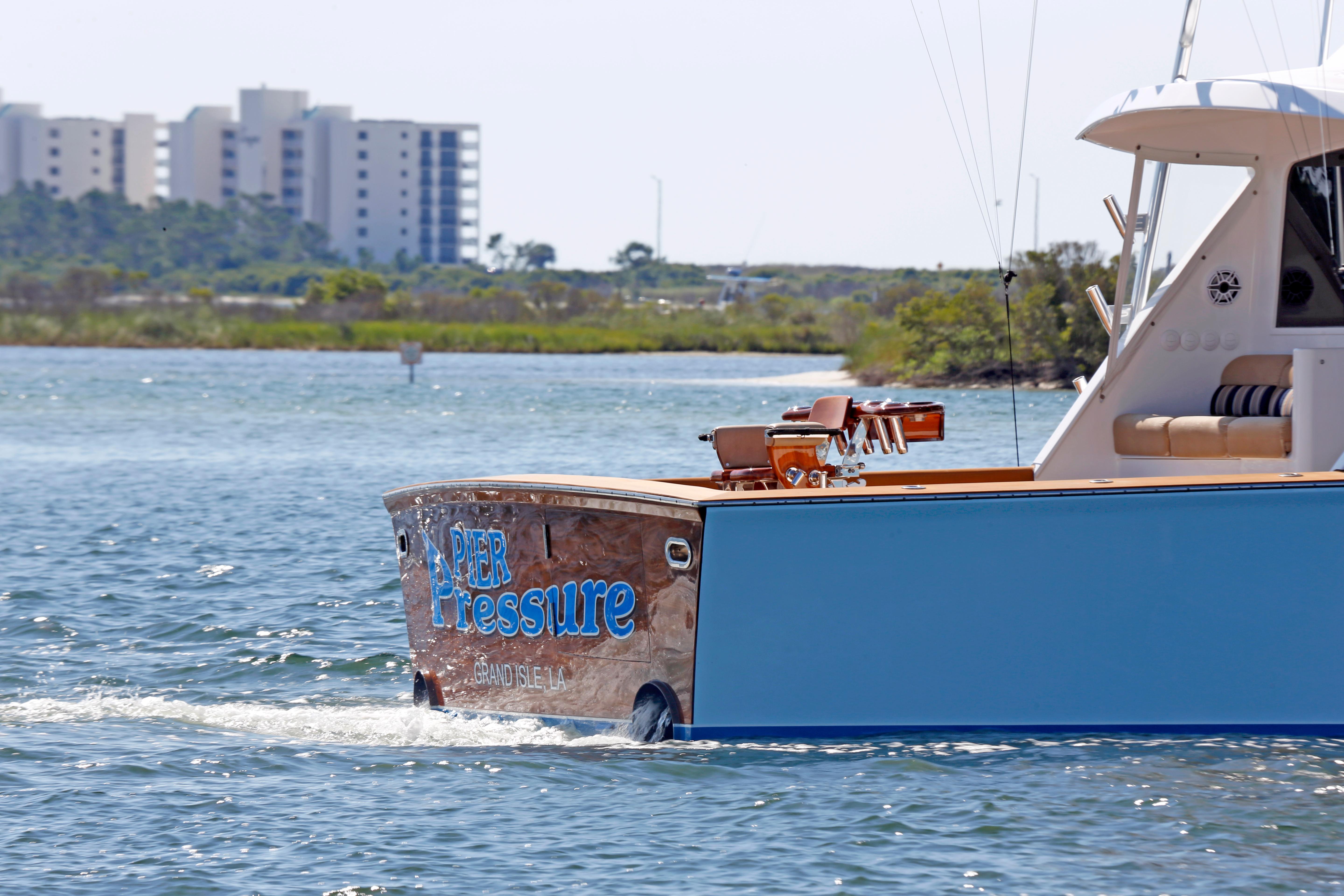 Jim Smith-65 Convertible 2000-PIER PRESSURE SC-US-Jim Smith 65 Convertible boat cruising near shoreline with buildings in the background.-9833594 | Thumbnail