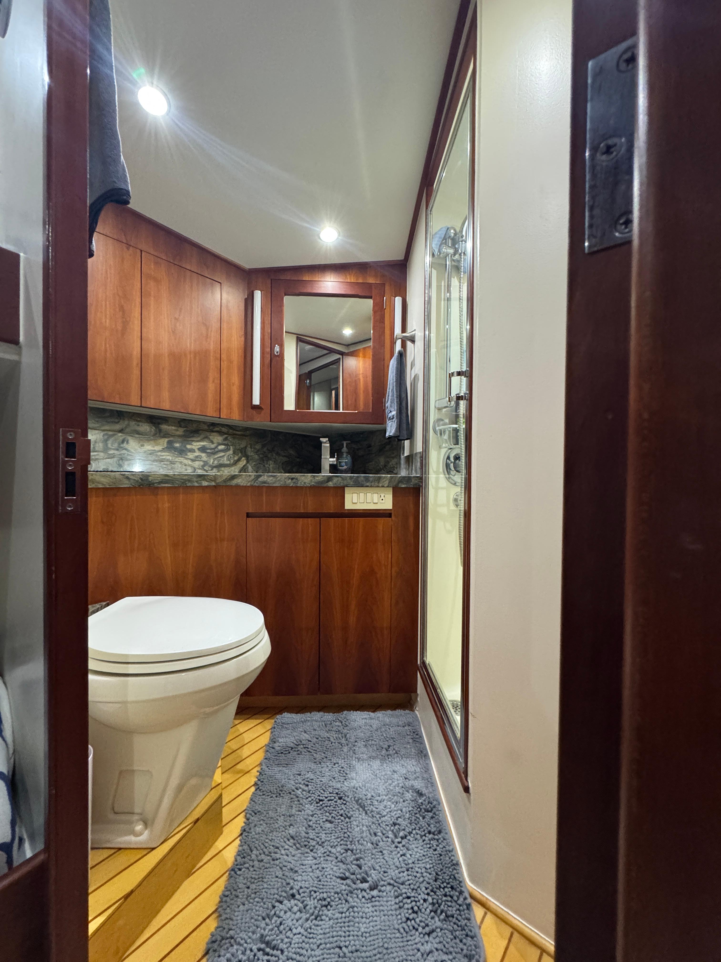 Jim Smith-65 Convertible 2000-PIER PRESSURE SC-US-Luxurious bathroom in 2000 Jim Smith 65 Convertible yacht with wood accents and modern fixtures.-9833594 | Thumbnail