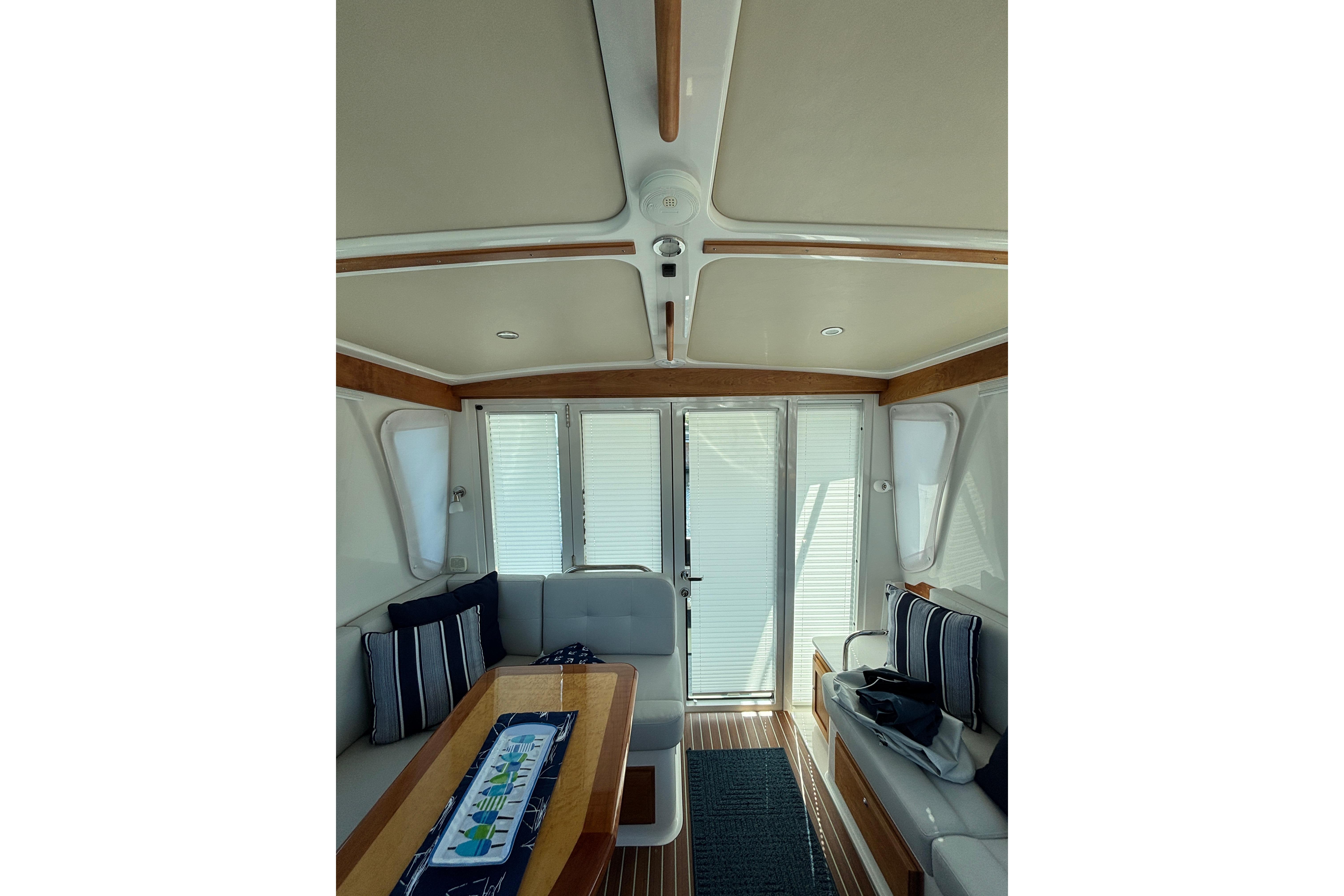 Interior of 2020 Back Cove 37 yacht with elegant seating and wooden accents.