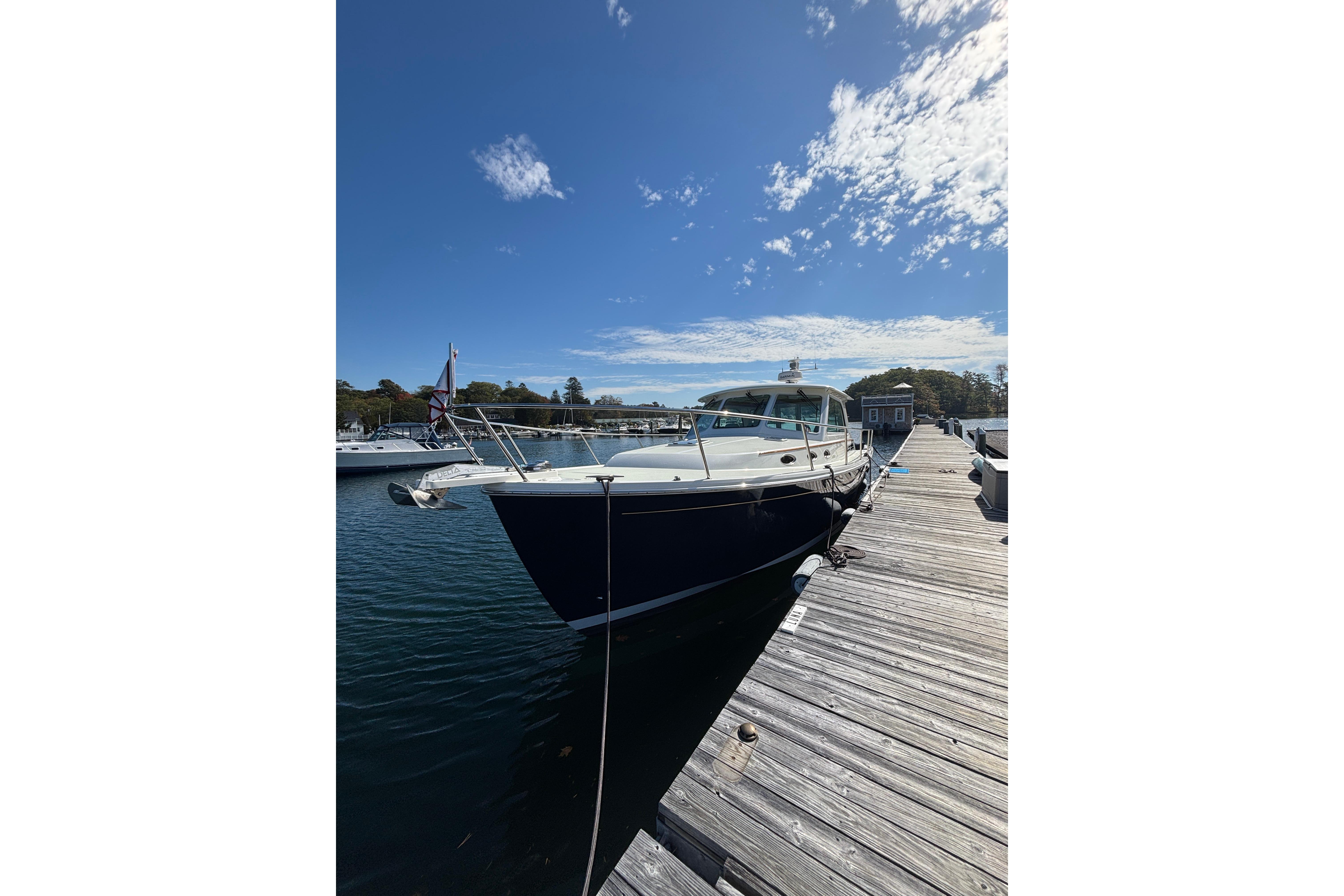 2020 Back Cove 37 yacht docked at a marina under a clear blue sky.