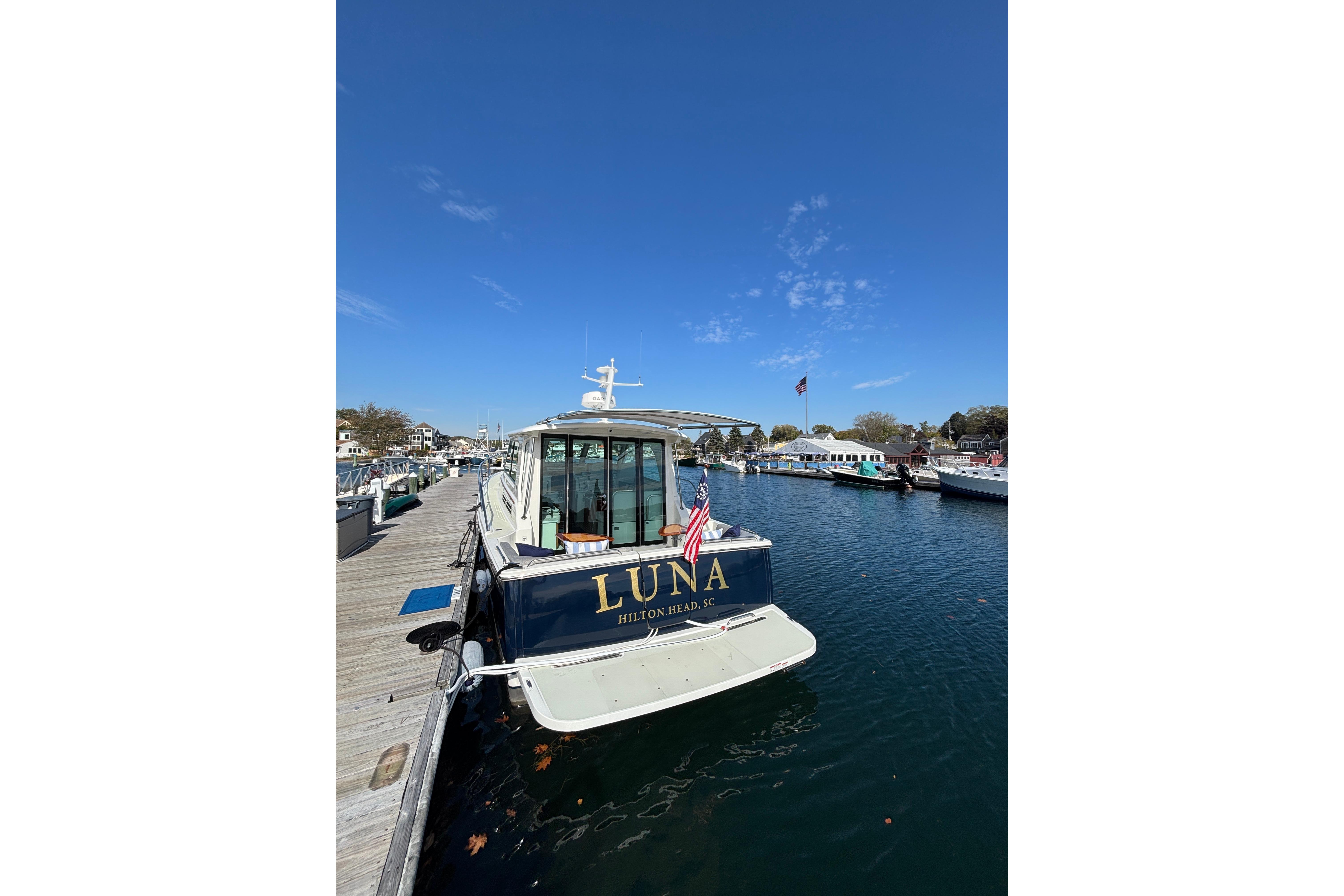Back Cove 37 yacht, 2020 model, docked at marina under clear blue sky.