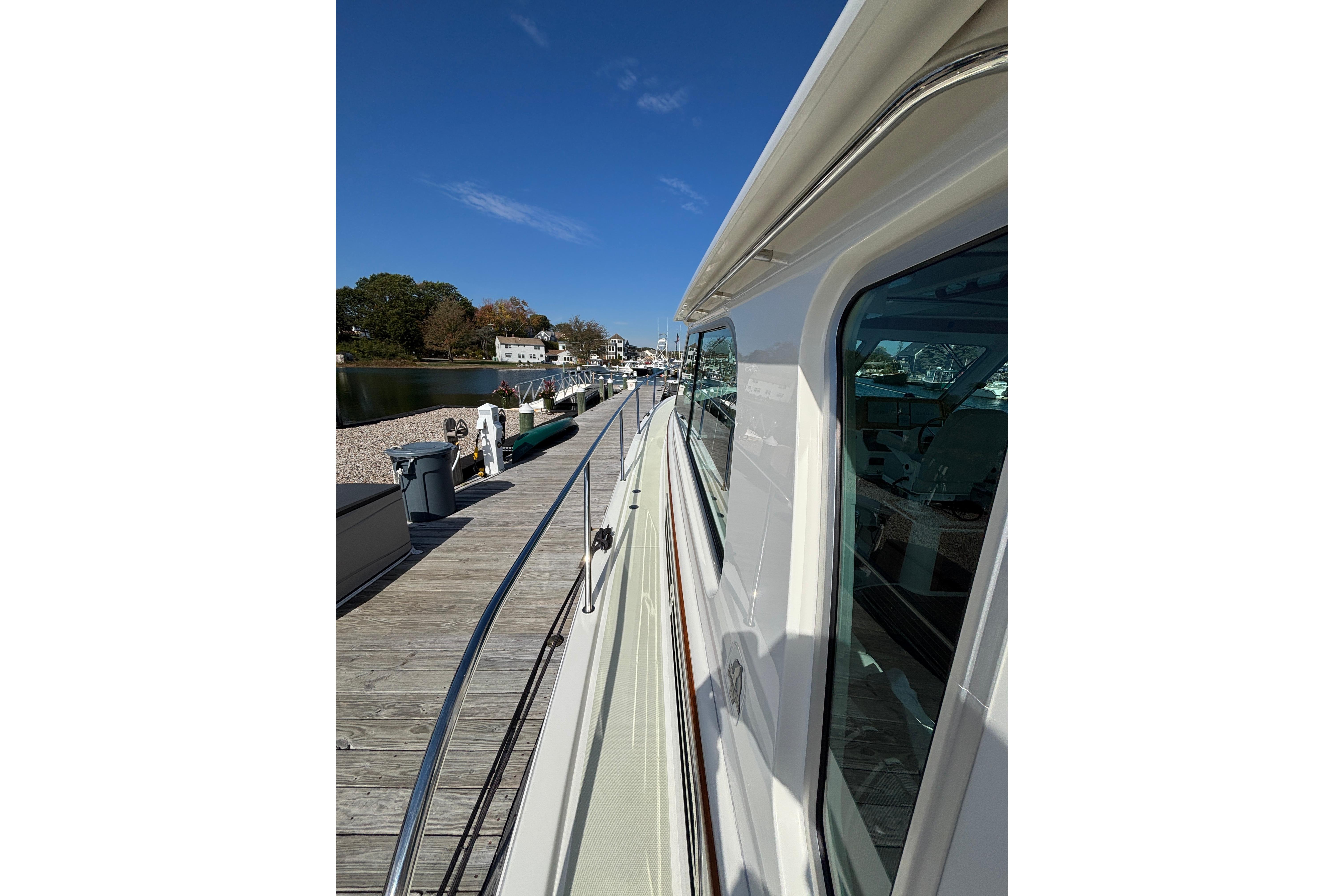 2020 Back Cove 37 yacht docked, showcasing sleek design and waterfront view.