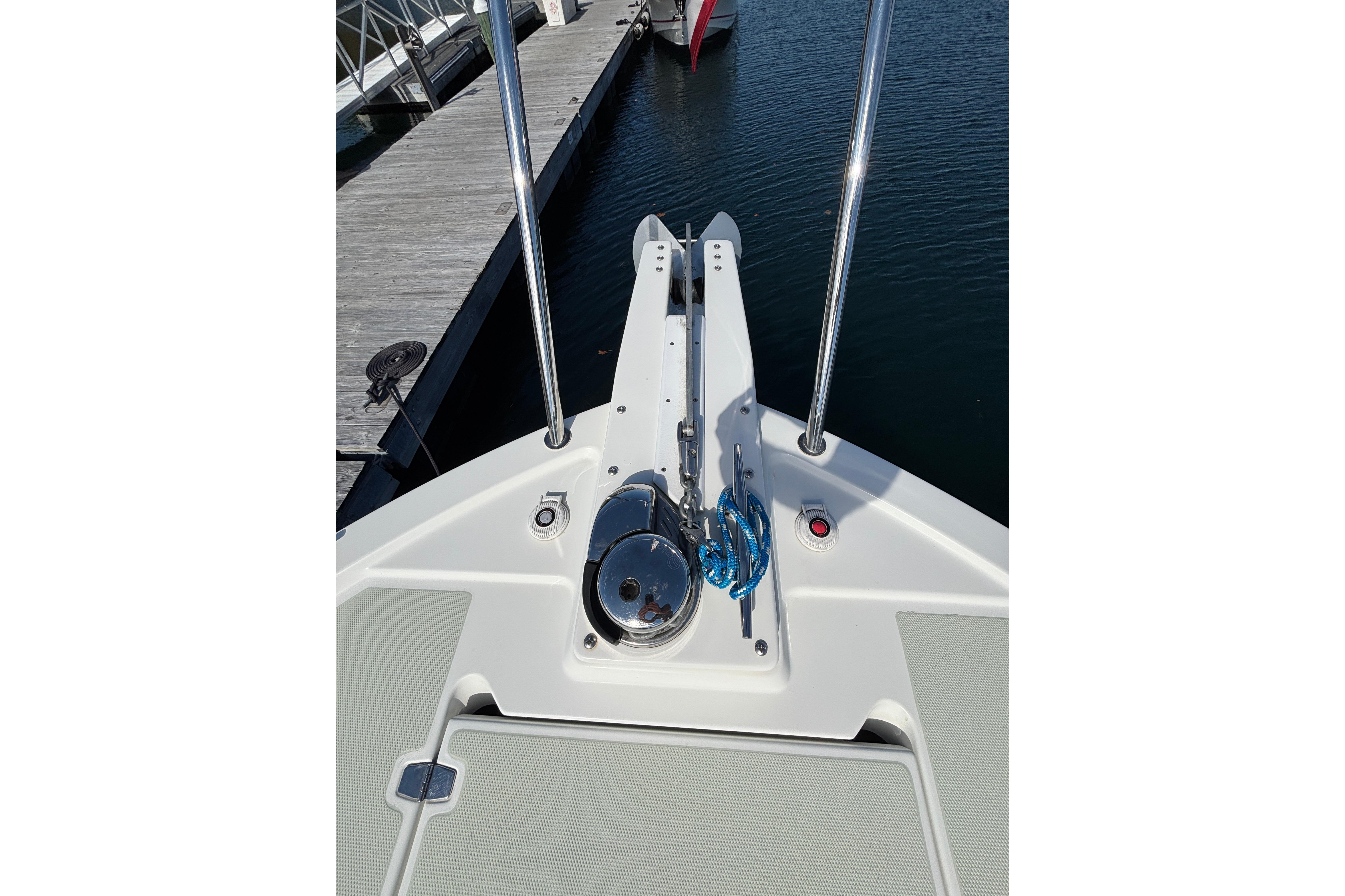 Bow of 2020 Back Cove 37 boat with anchor and blue rope at dock.