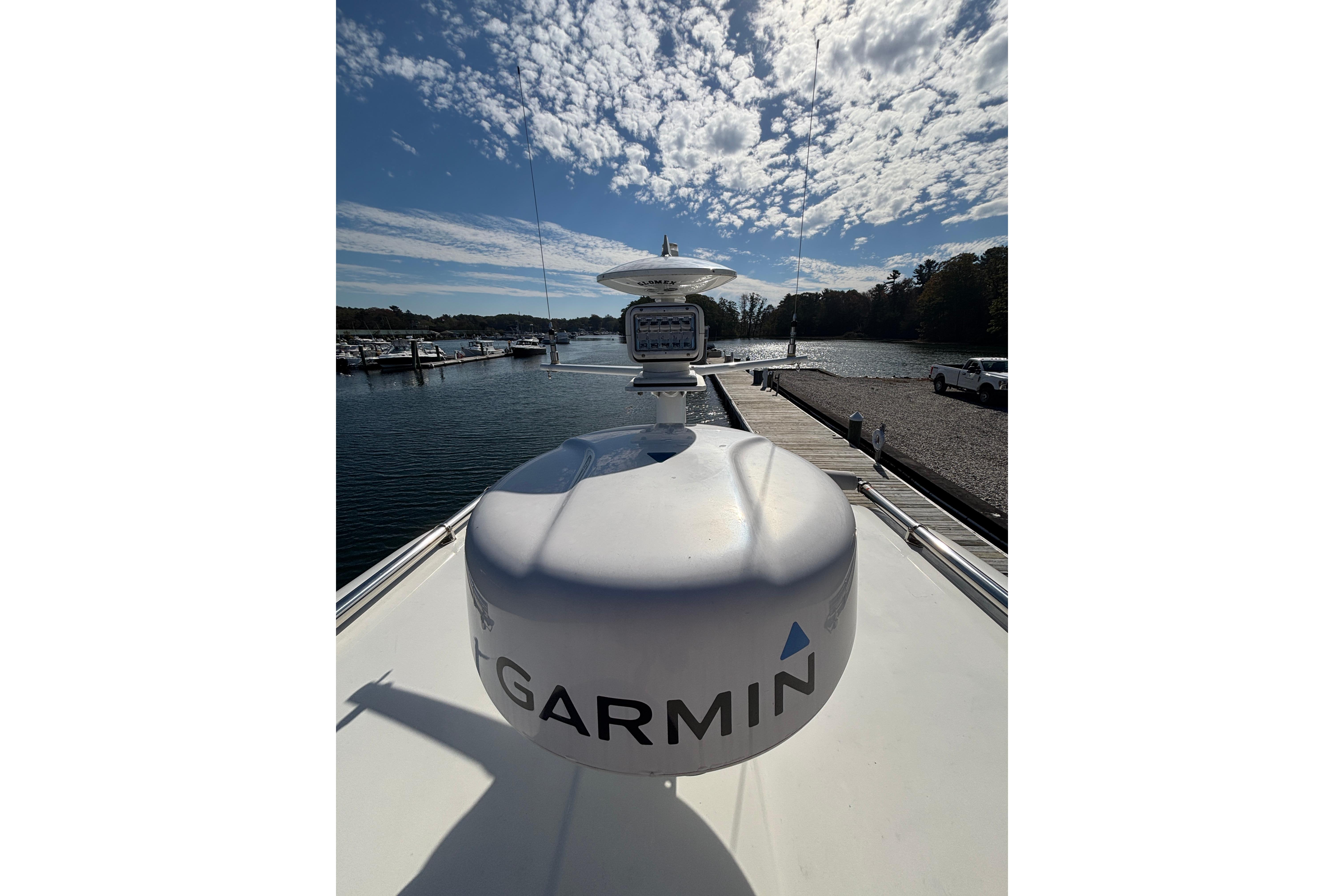 2020 Back Cove 37 yacht with Garmin radar, docked under a partly cloudy sky.