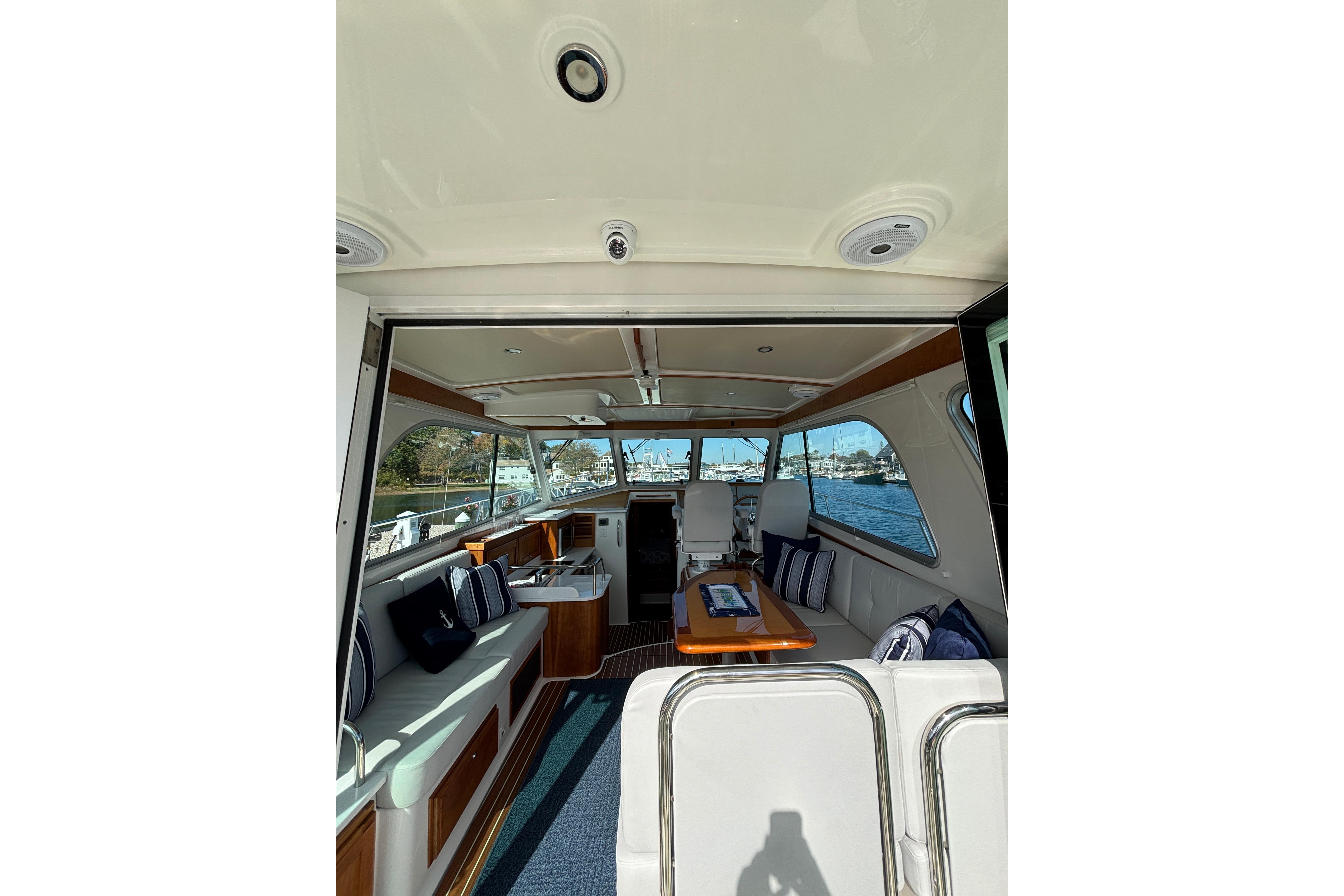 Interior view of 2020 Back Cove 37 yacht, featuring elegant seating and a scenic water backdrop.