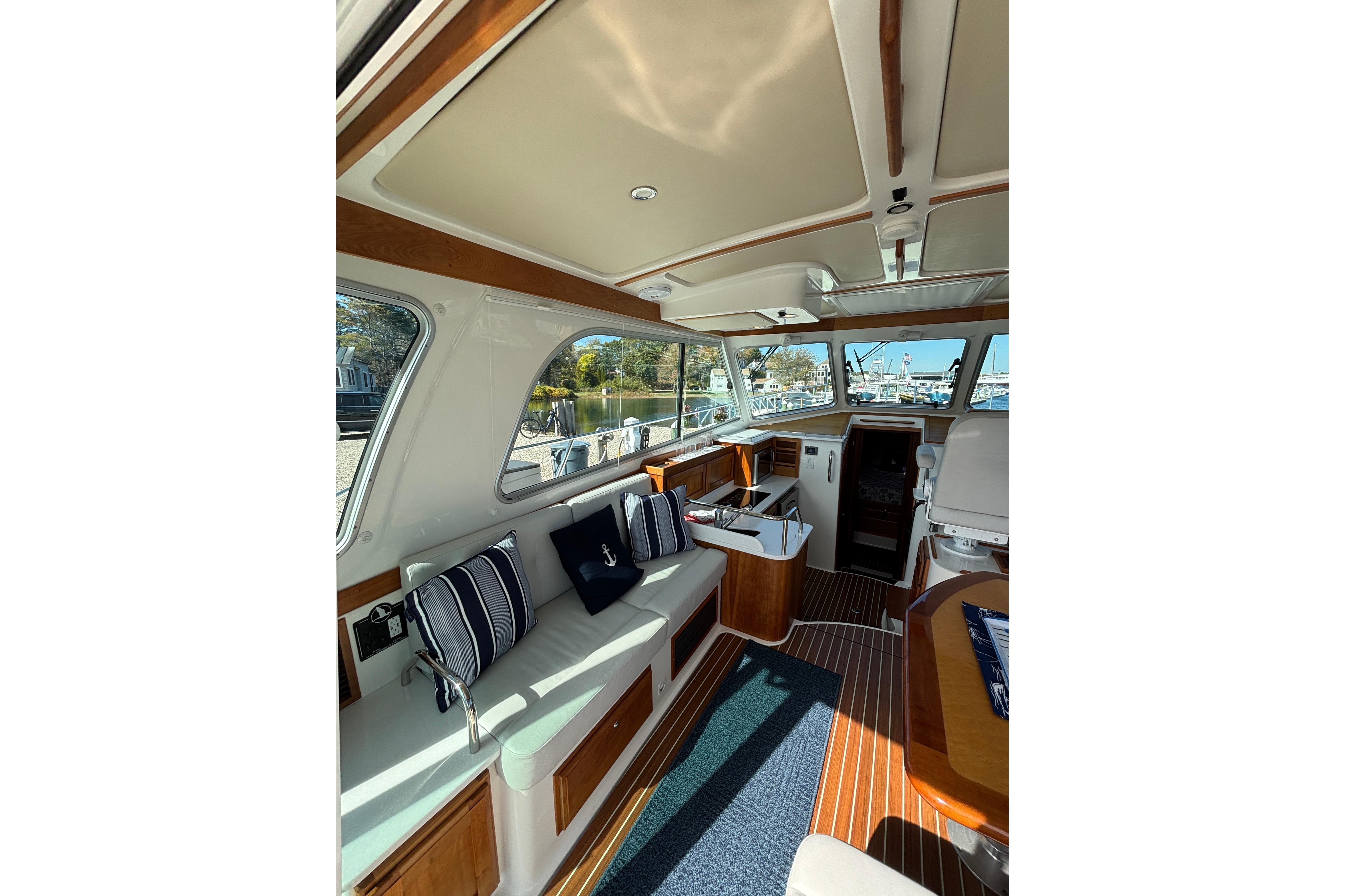 Interior of 2020 Back Cove 37 yacht with elegant seating and wood accents.