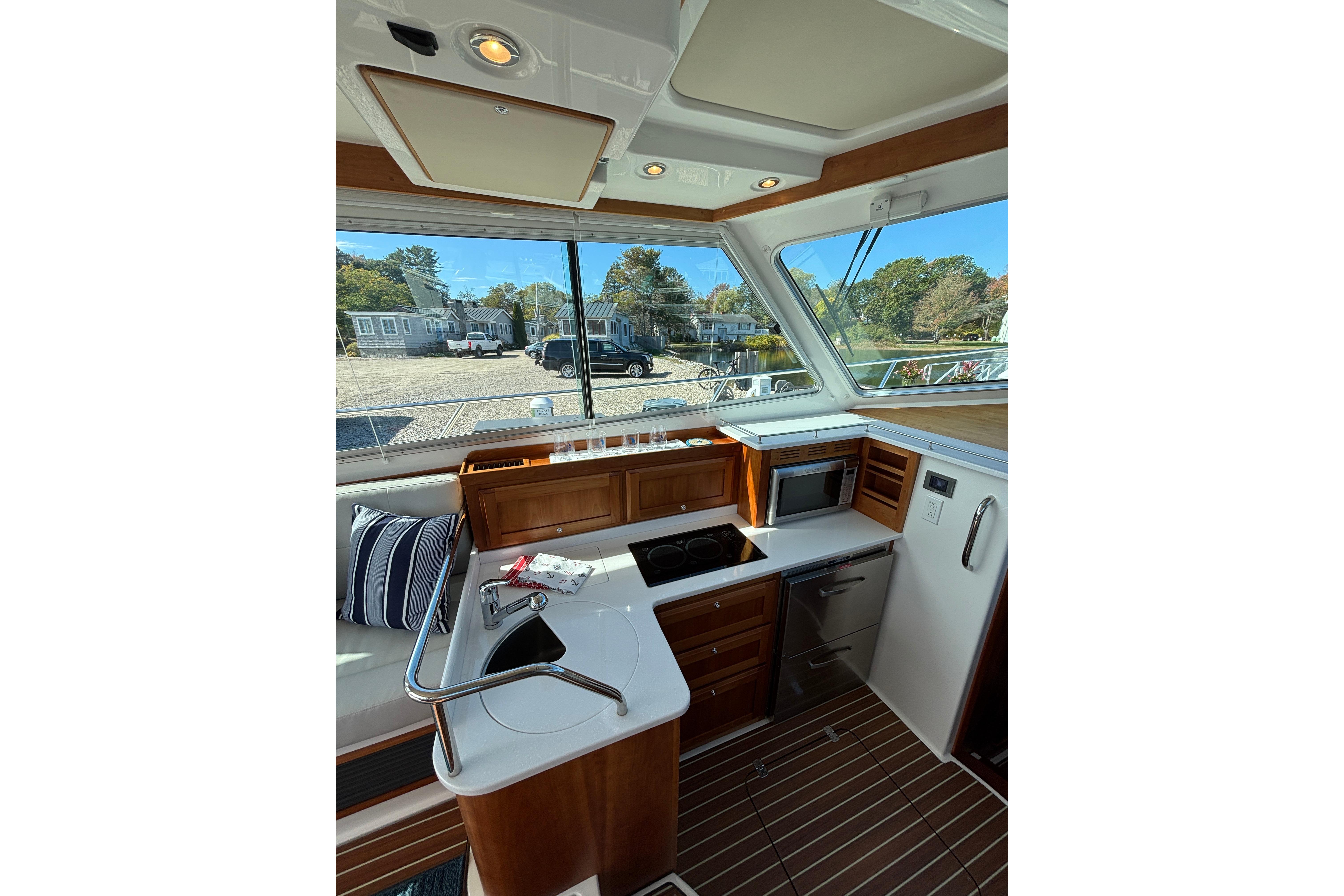 Interior of 2020 Back Cove 37 yacht, featuring a modern kitchen with wood accents.