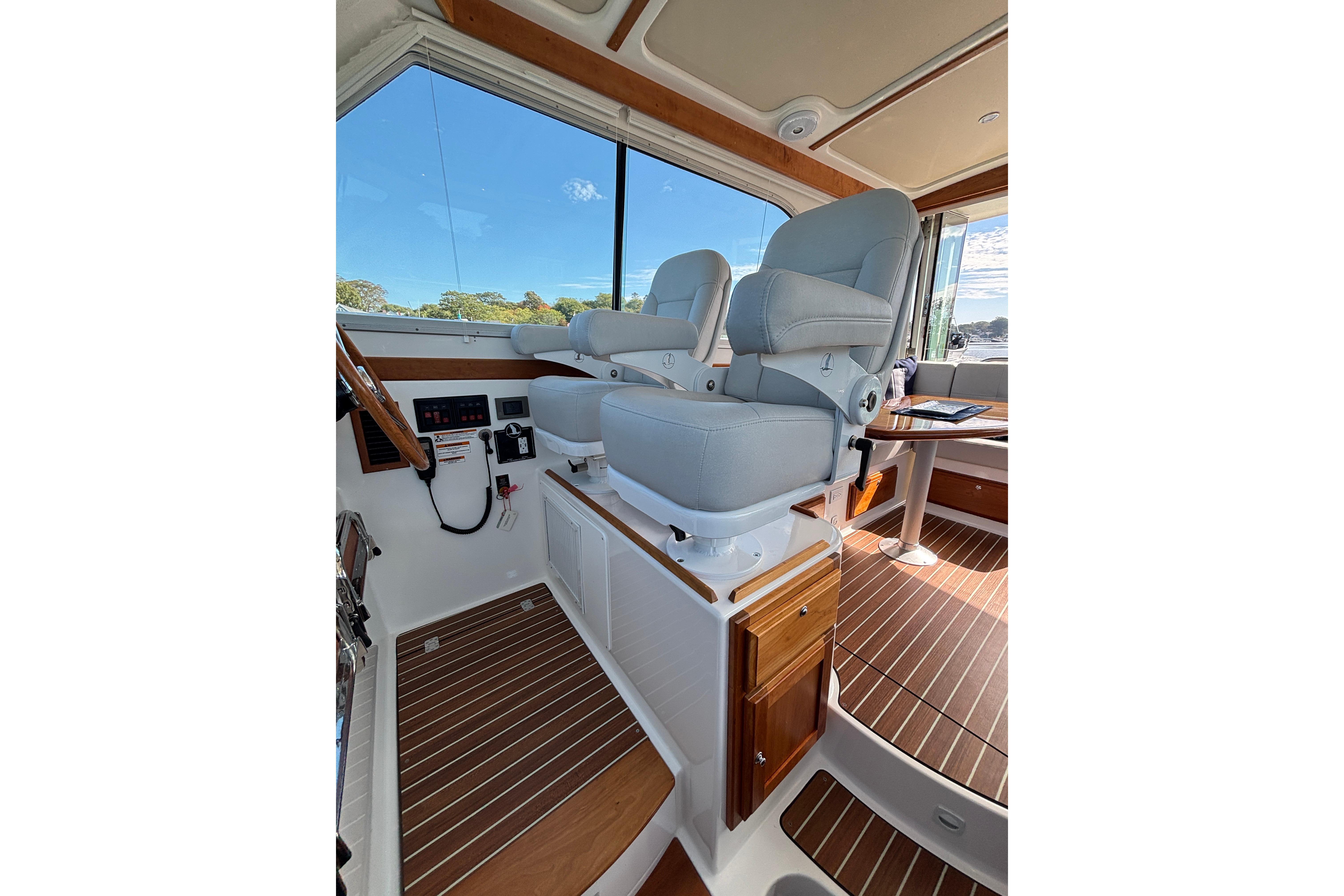 2020 Back Cove 37 interior with helm seats and wooden flooring.