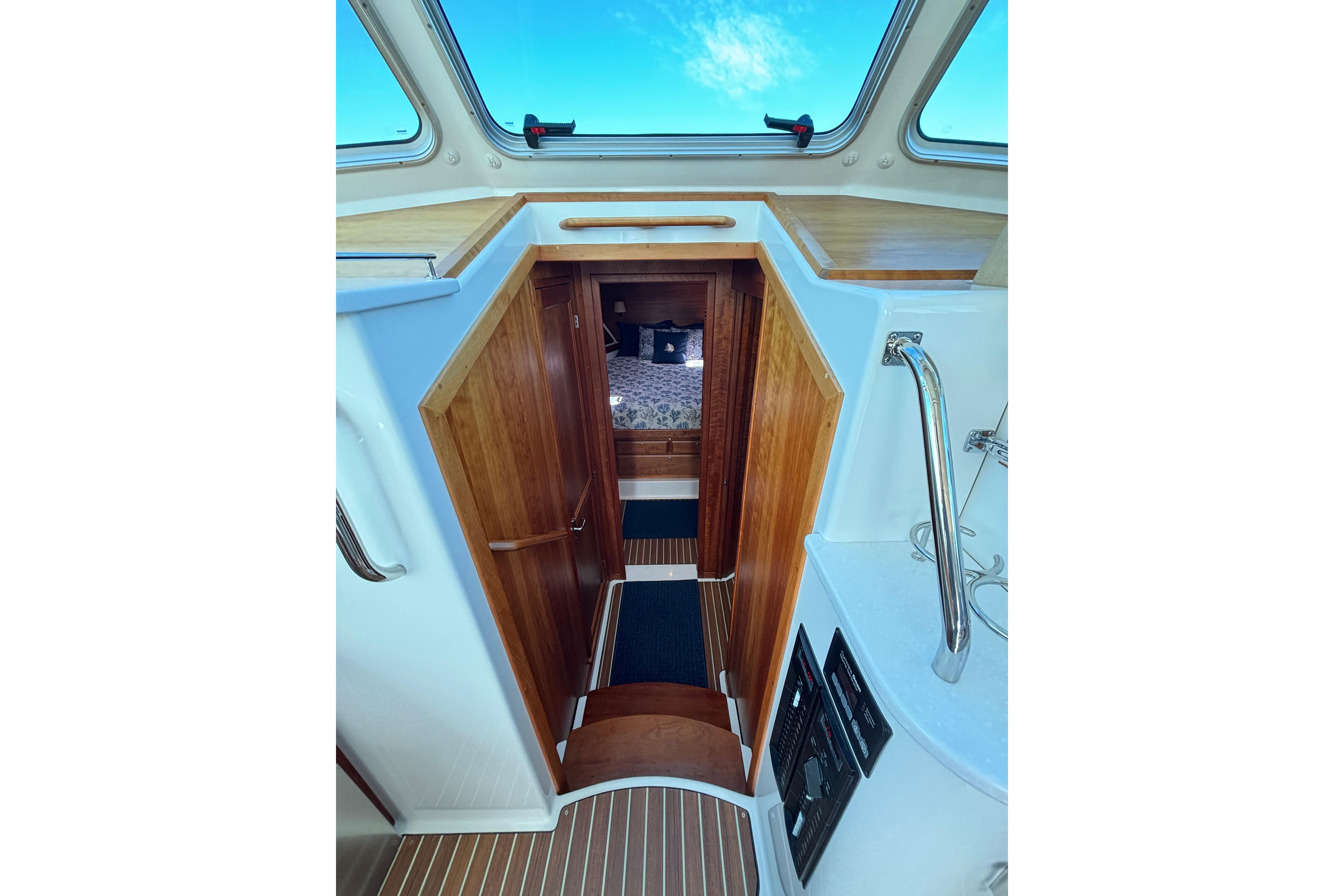 Interior view of 2020 Back Cove 37 yacht, featuring wooden cabinetry and skylight.