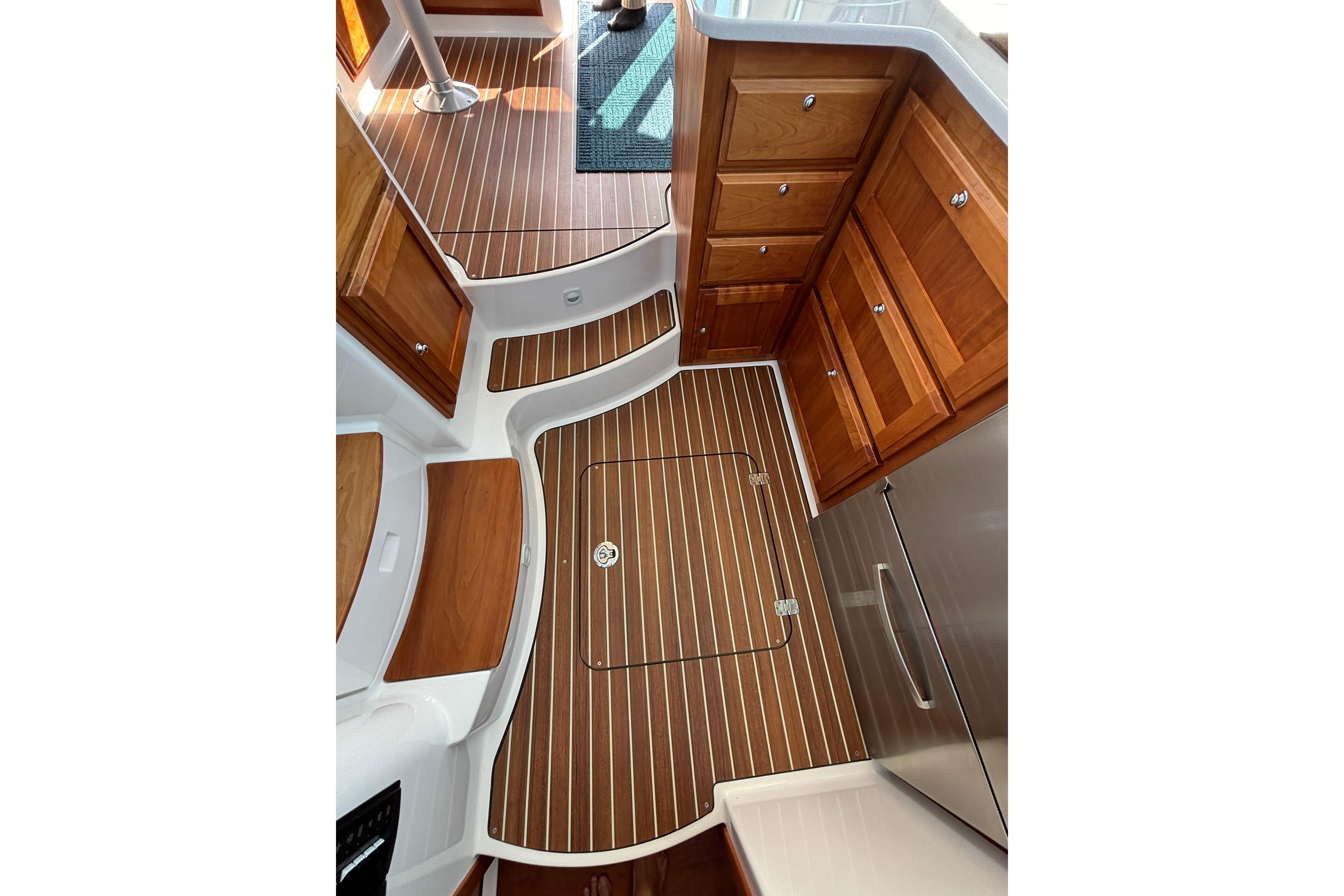 2020 Back Cove 37 interior with wood cabinetry and striped flooring.