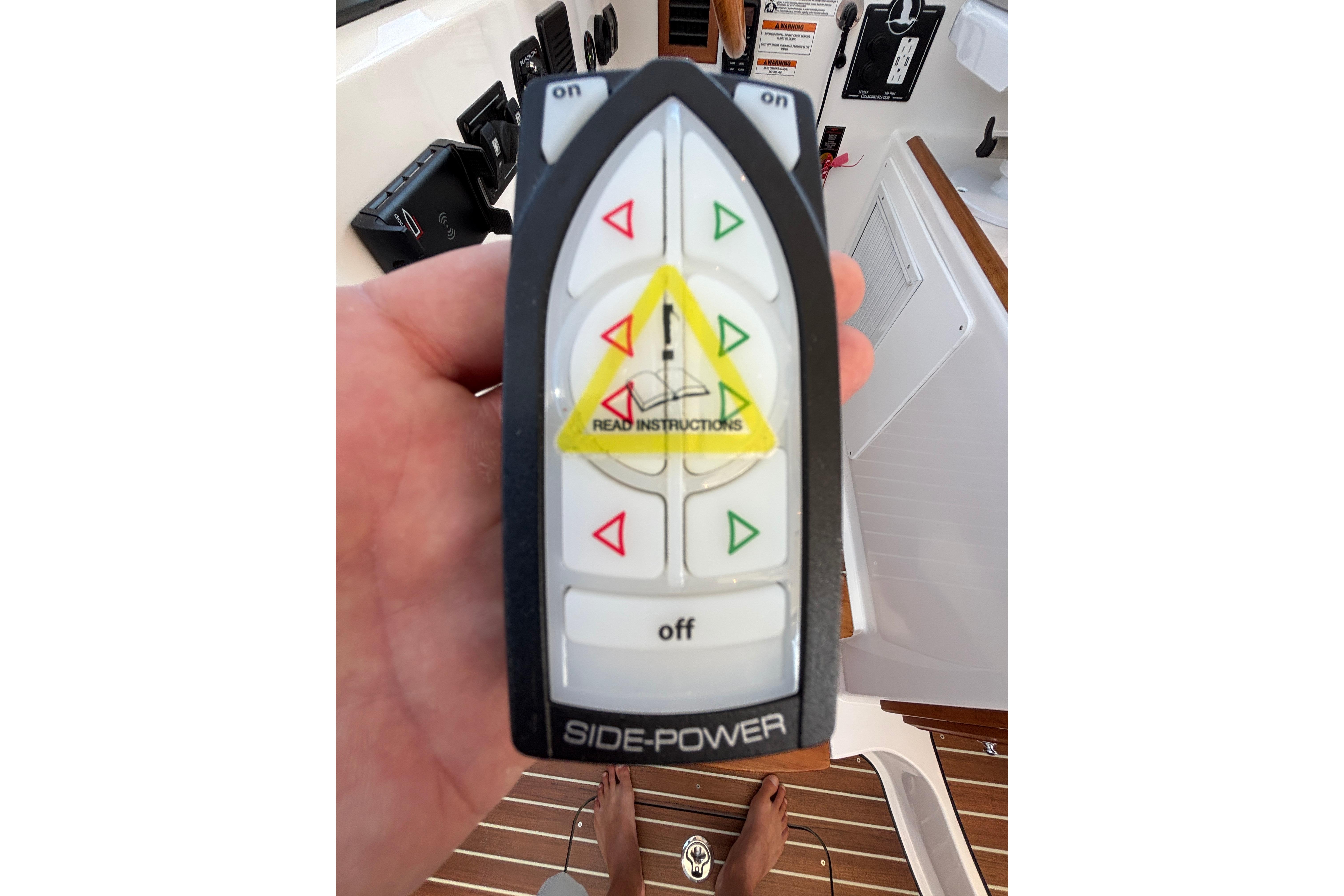 Hand holding Side-Power remote control on 2020 Back Cove 37 boat.