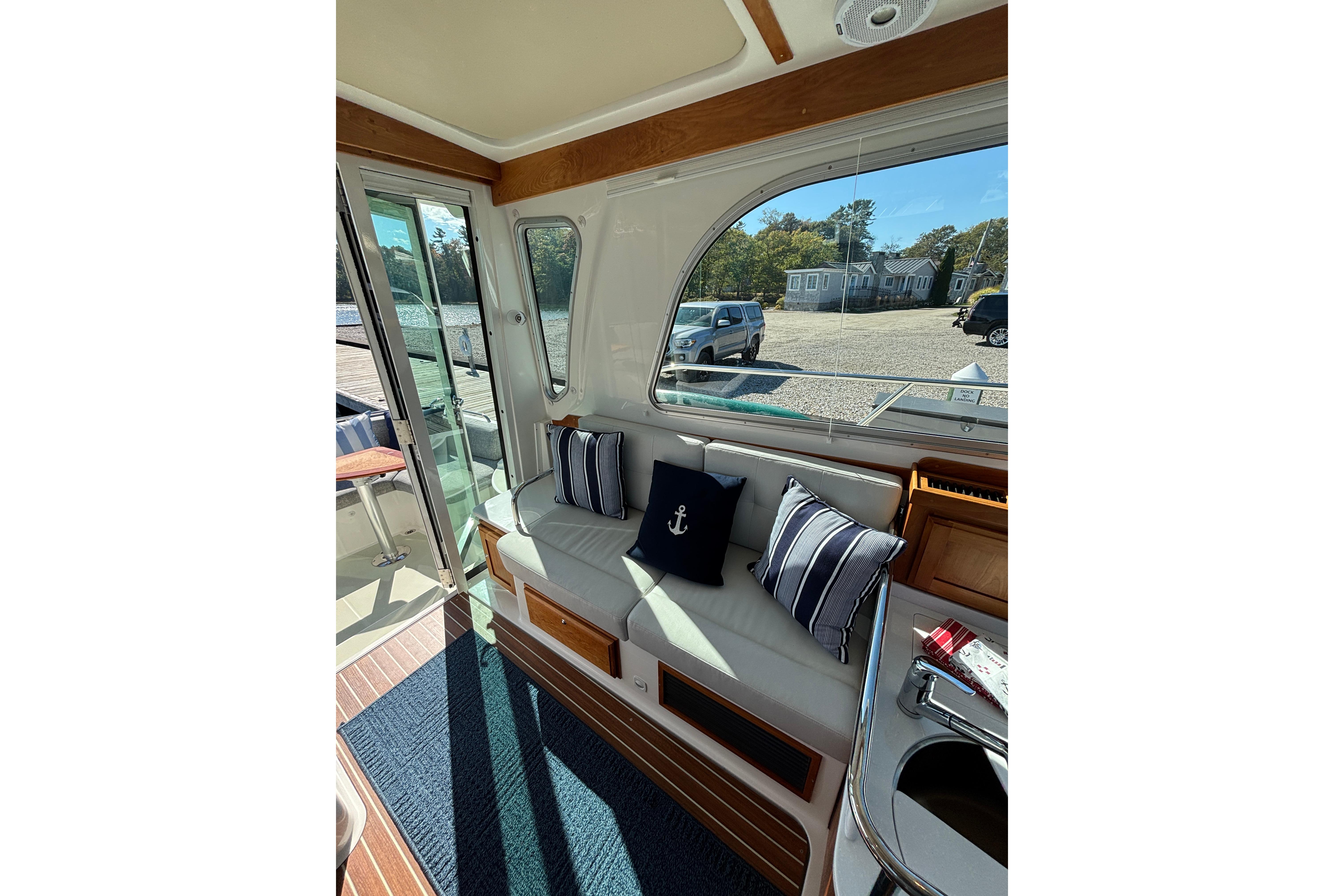 Interior of 2020 Back Cove 37 yacht with cozy seating and nautical decor.